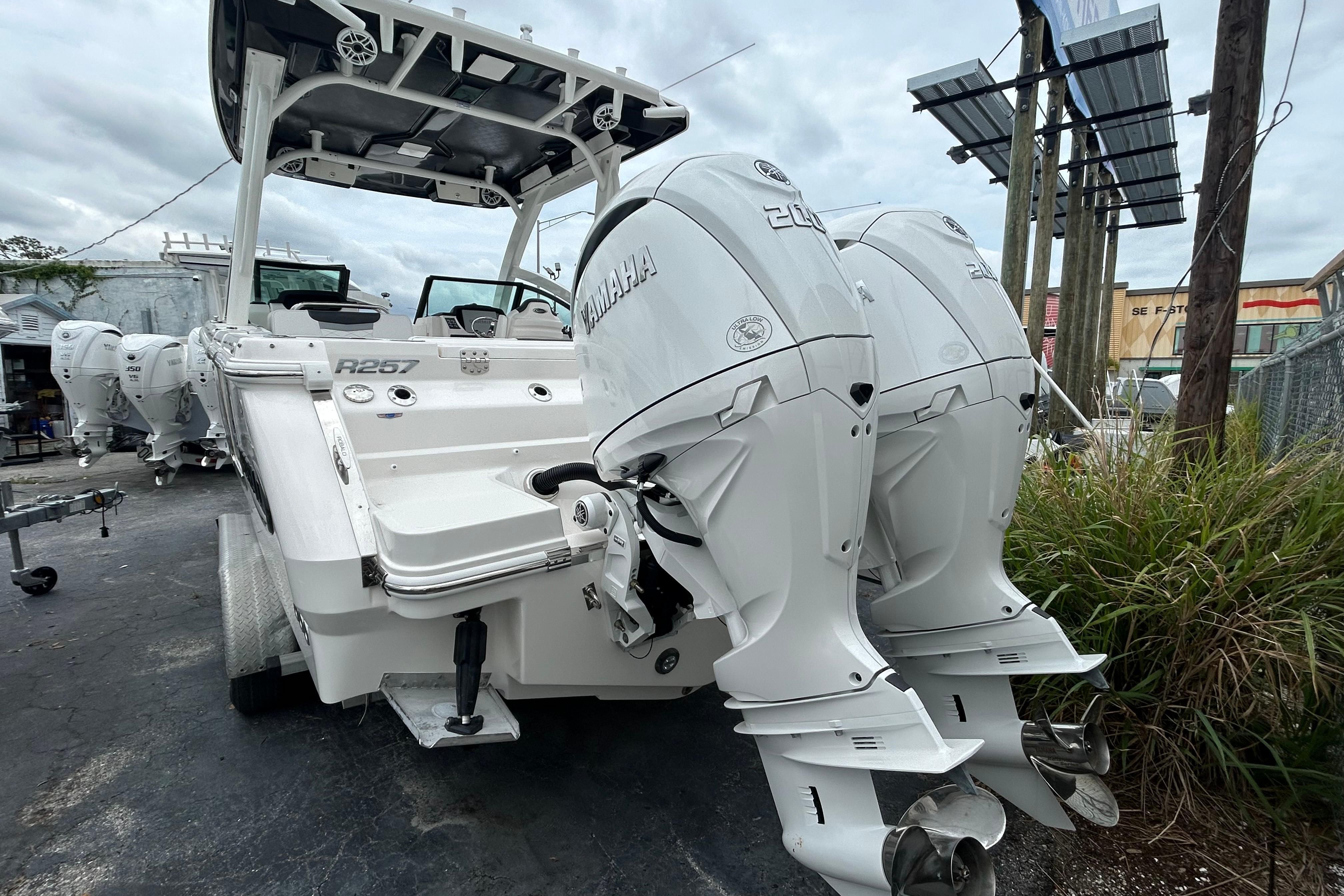 2026 Robalo R257 Dual Console boat with twin Yamaha outboard engines, parked outdoors.