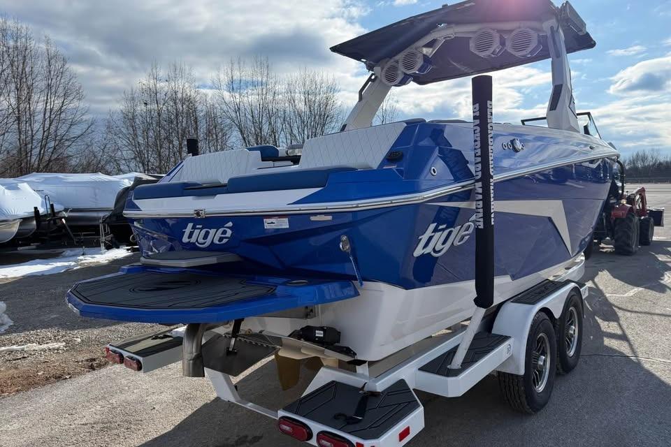 2026 Tigé Z3 boat in blue and white on a trailer, parked outdoors.