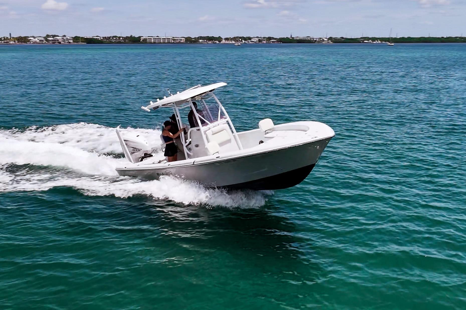 2019 Blue Wave 2800 Pure Hybrid boat cruising on clear blue water.