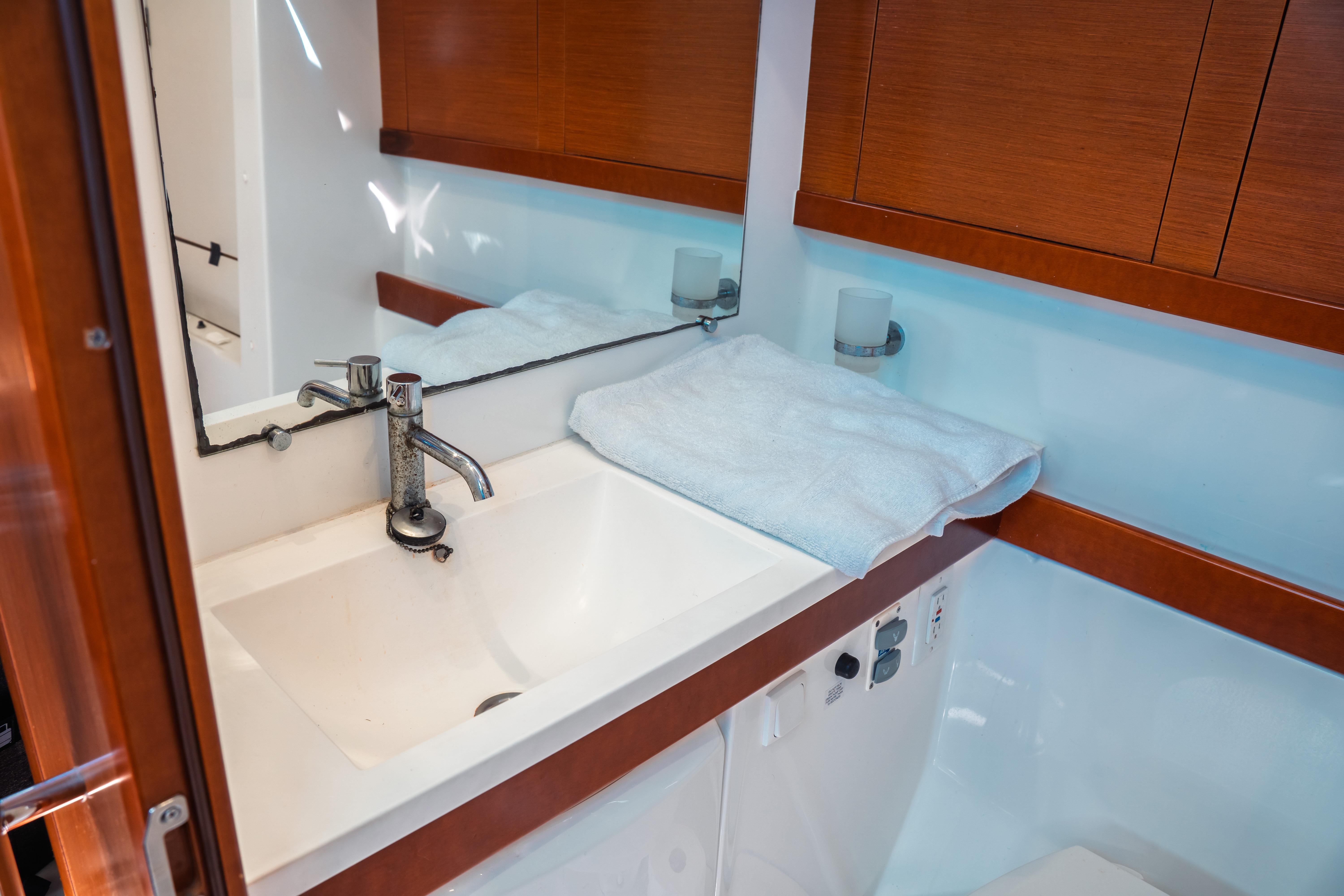 Beneteau Oceanis 50 bathroom sink with wooden cabinetry, 2011 model.