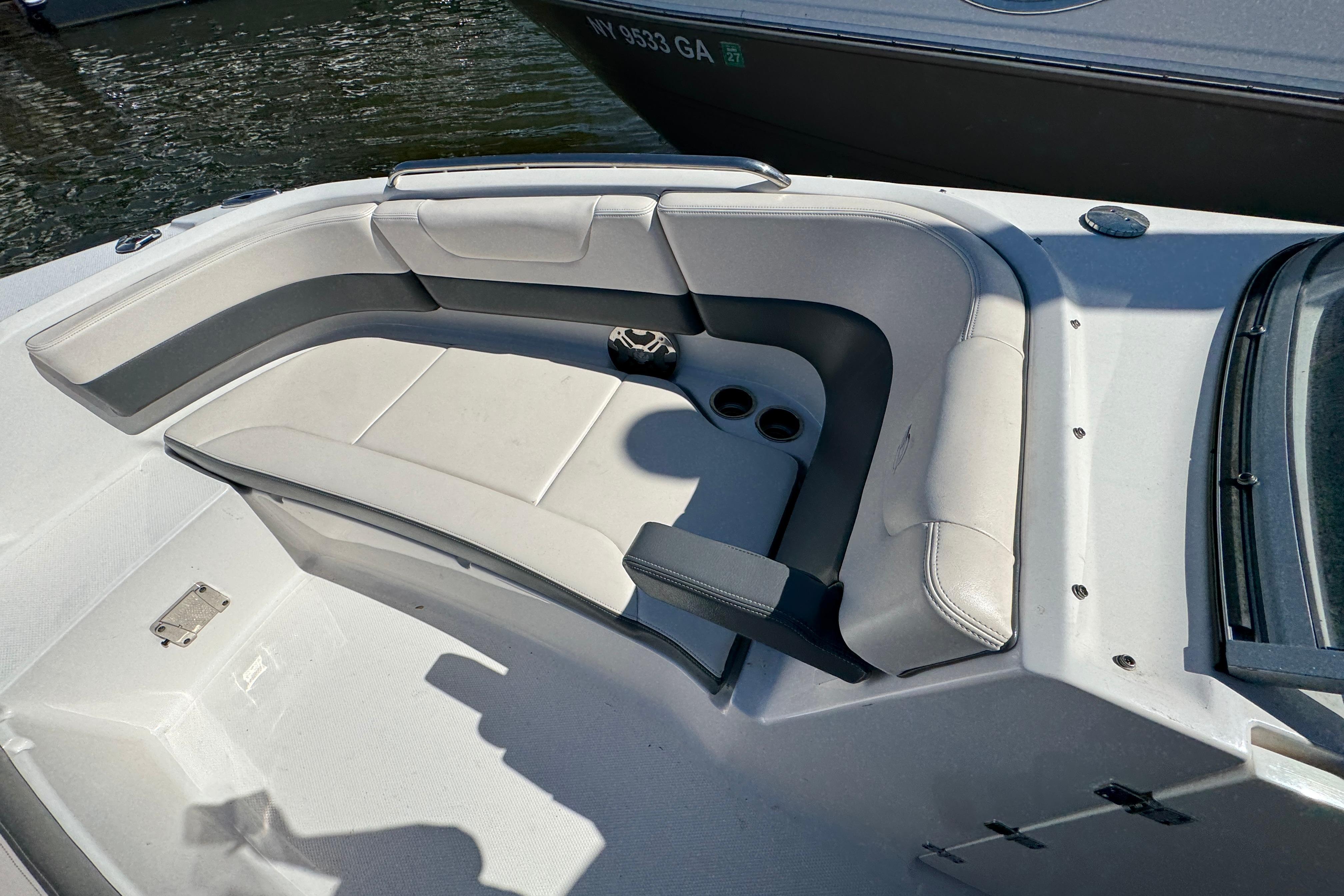 2018 Chaparral 250 Suncoast boat interior with cushioned seating and cup holders.