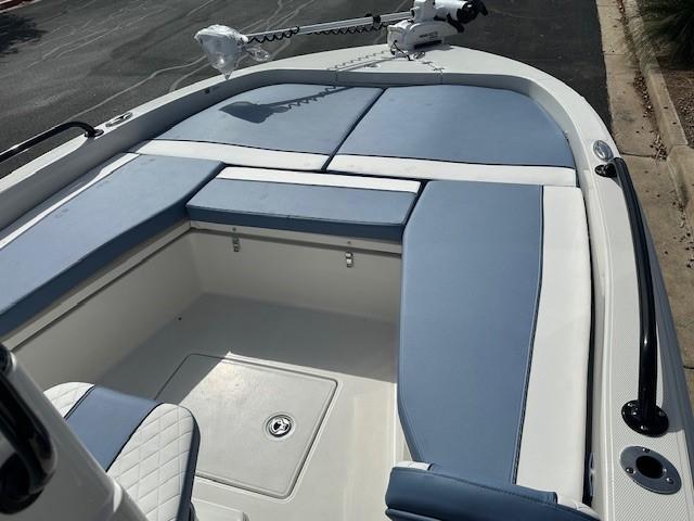 2025 Ranger 2360 Bay boat with blue and white seating, docked on a sunny day.