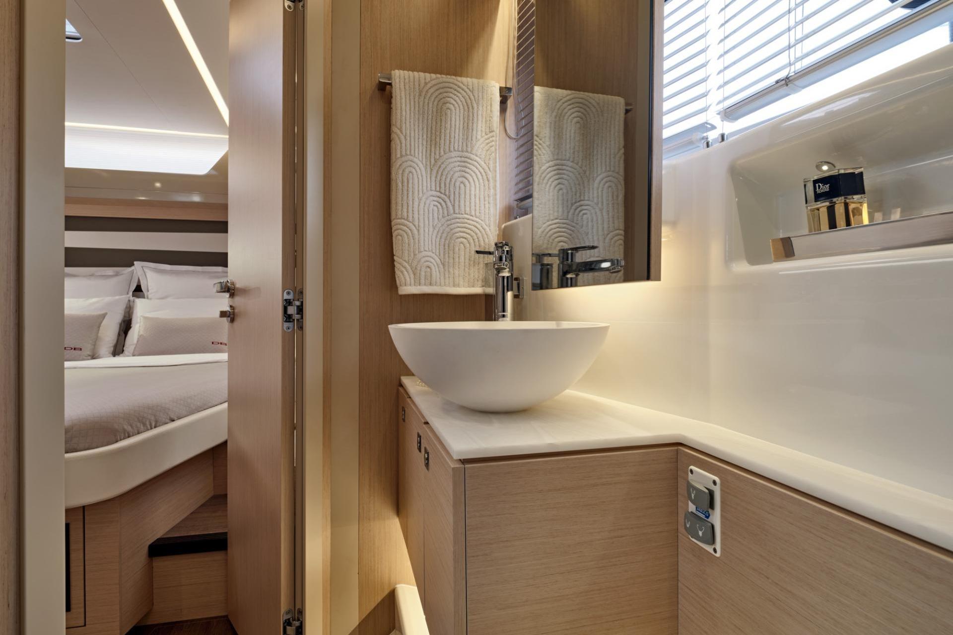 Luxurious bathroom interior of 2027 Jeanneau DB/43 OB yacht with modern sink and elegant design.