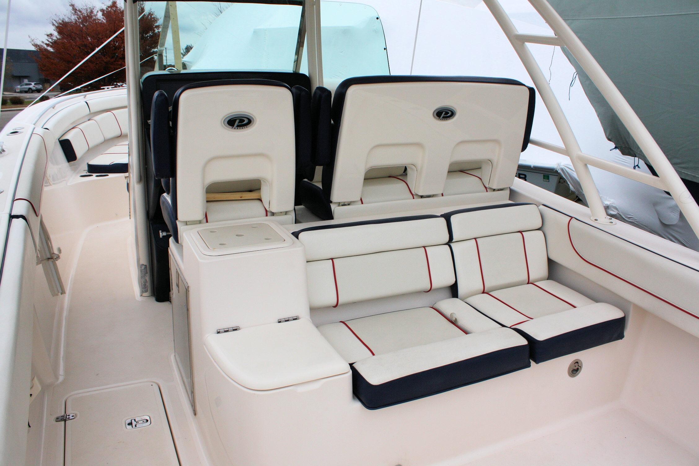 2013 Pursuit ST 310 Sport boat interior with cushioned seating and helm chairs.