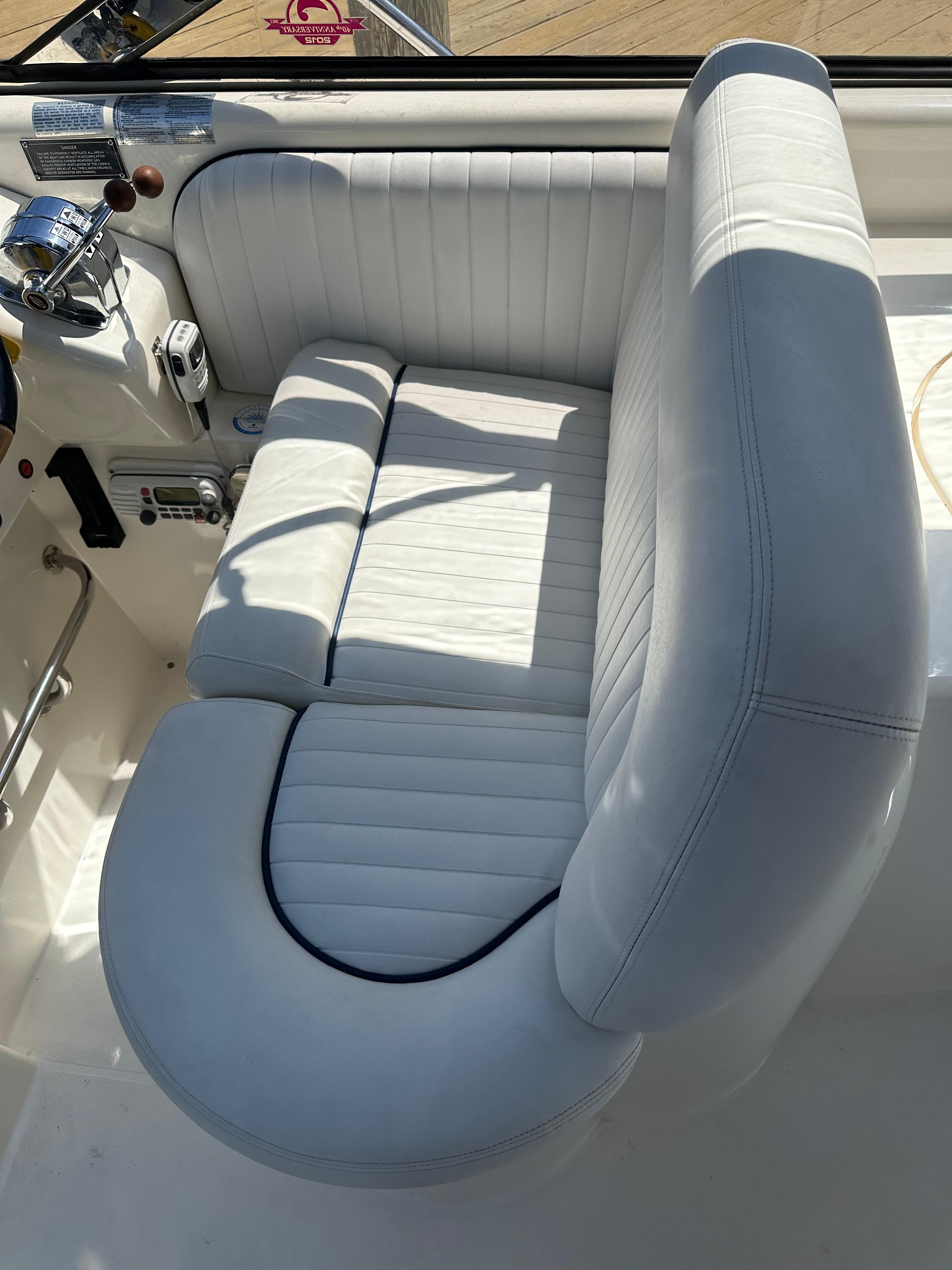 White leather seating on a 1997 Sunseeker Camargue 47 yacht, showcasing luxury and comfort.