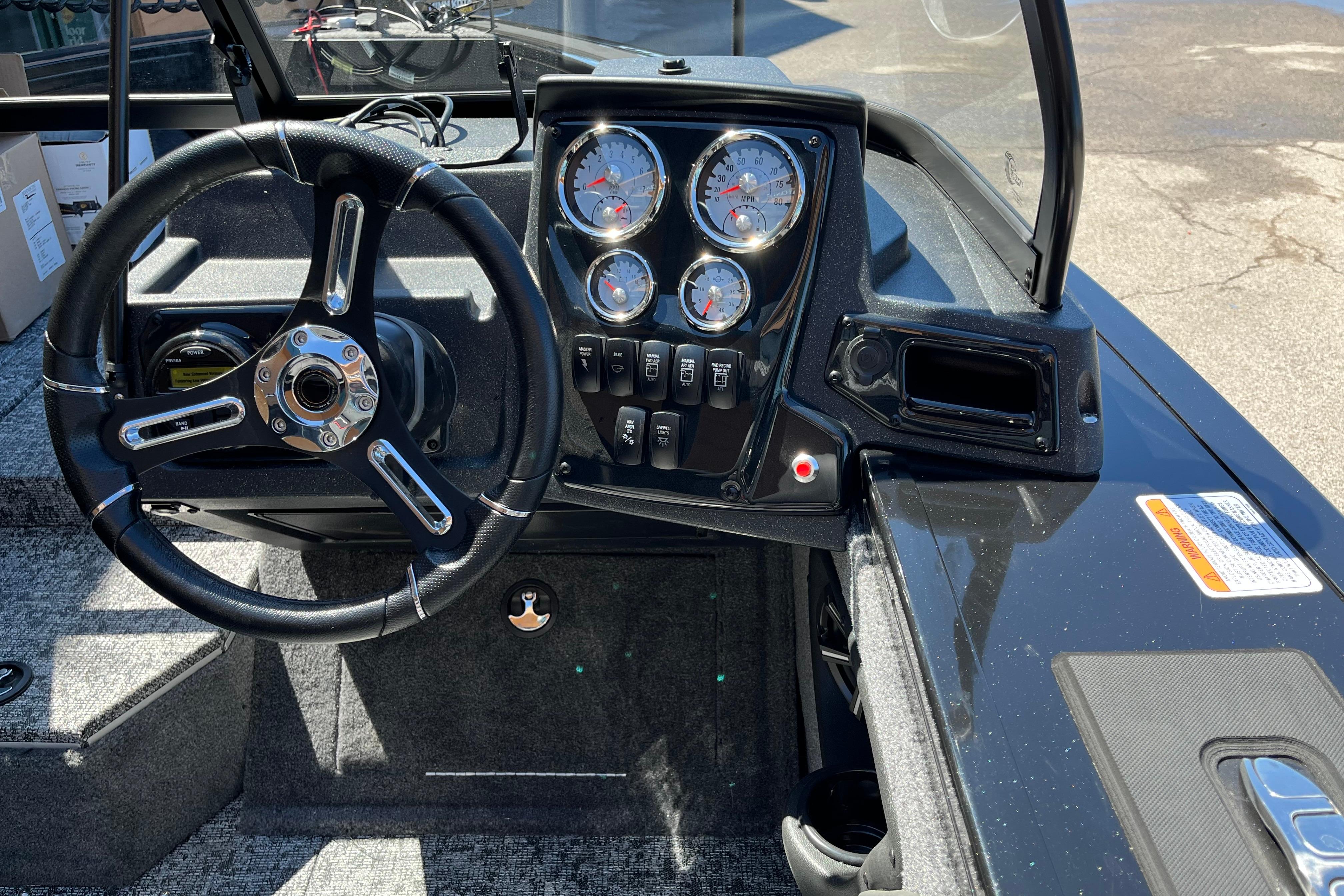 Steering console of 2026 Tracker Targa V-19 WT boat with gauges and controls.