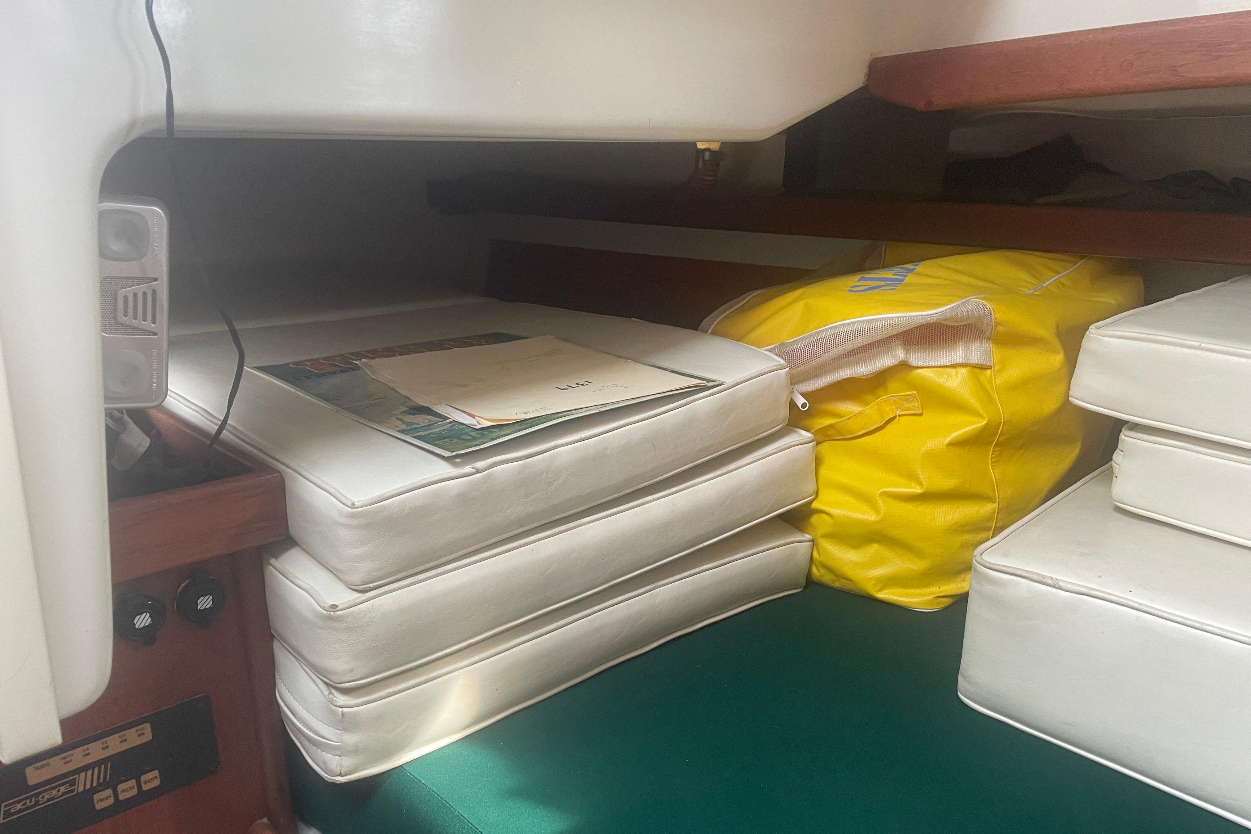 Interior of 1981 Nonsuch 30 Classic sailboat with cushions and yellow bag.