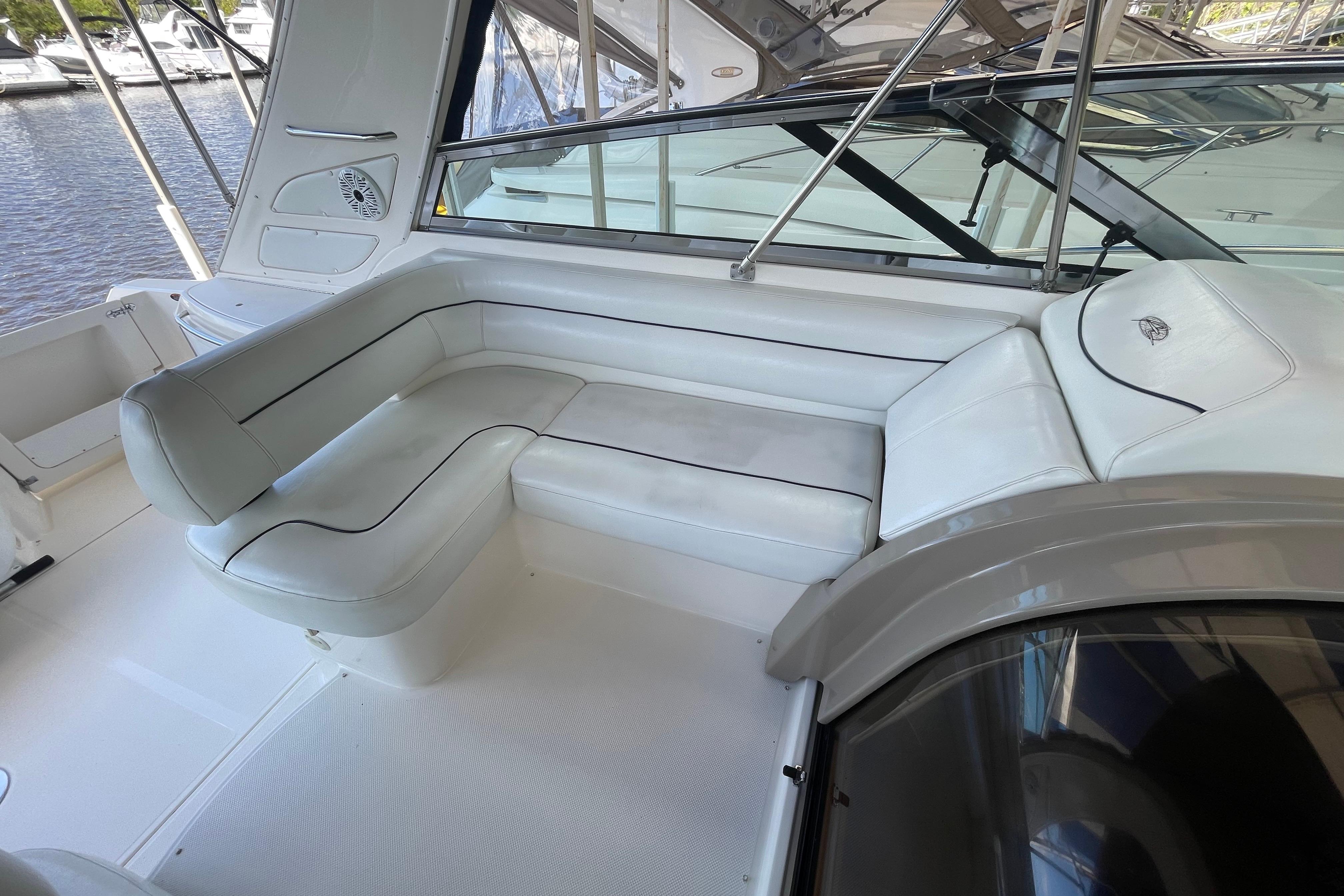 1997 Bayliner 4085 Avanti boat interior with white cushioned seating and sleek design.