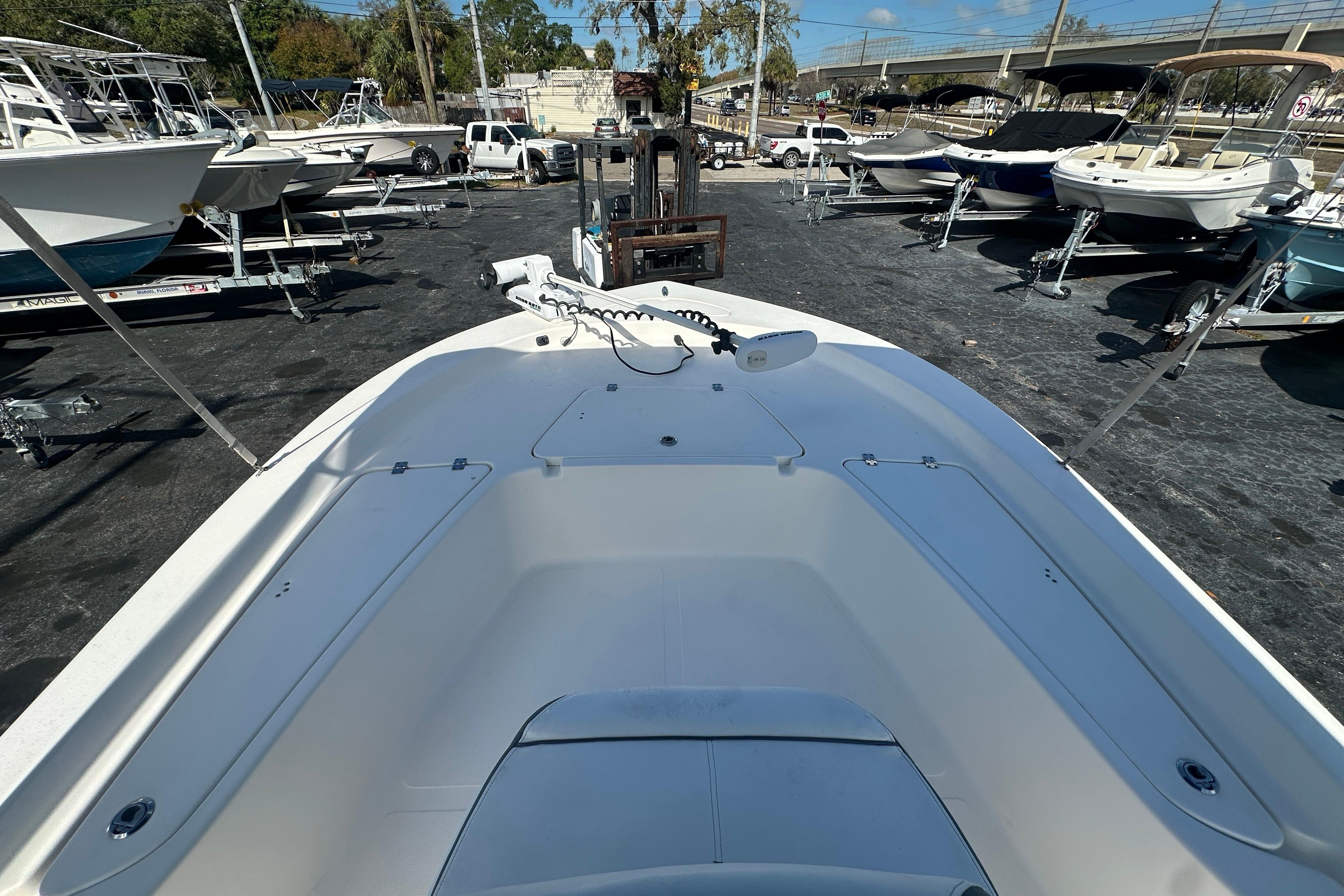 2015 Tidewater 2000 Carolina Bay boat in a marina, surrounded by other boats.