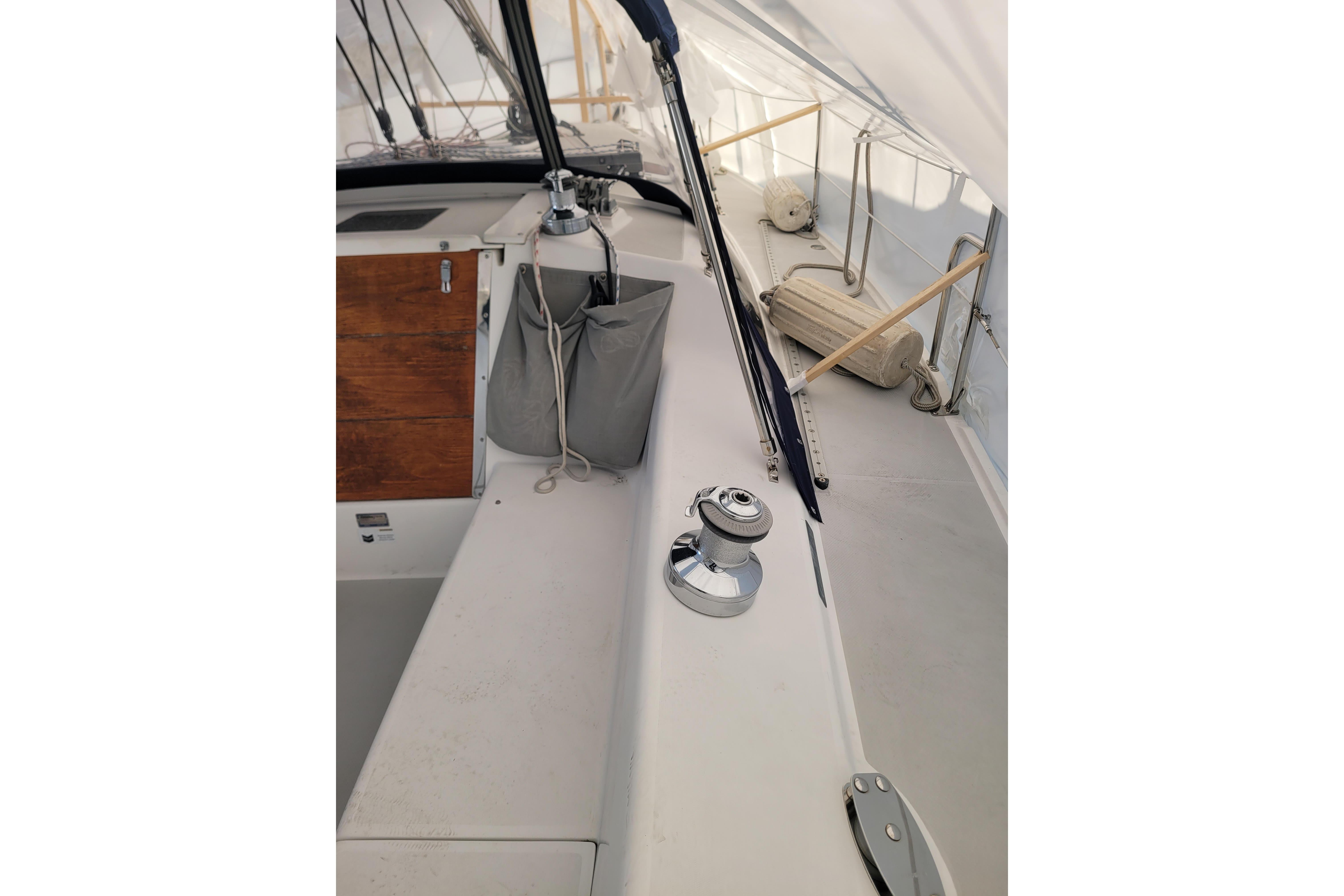 2006 Catalina 320 sailboat deck with winch and storage compartments.