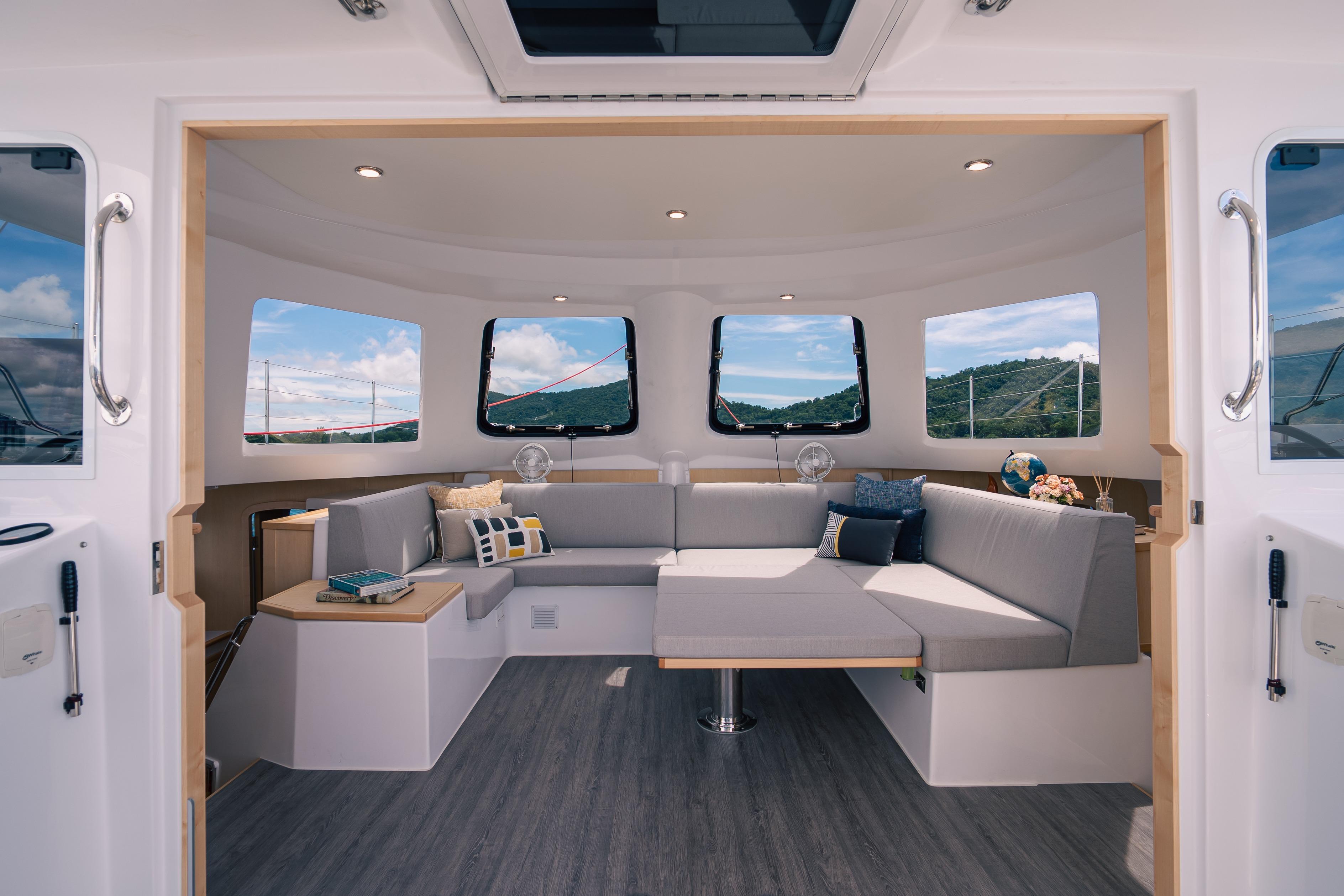 Luxurious interior of 2026 Seawind 1160XL catamaran with modern seating and panoramic windows.