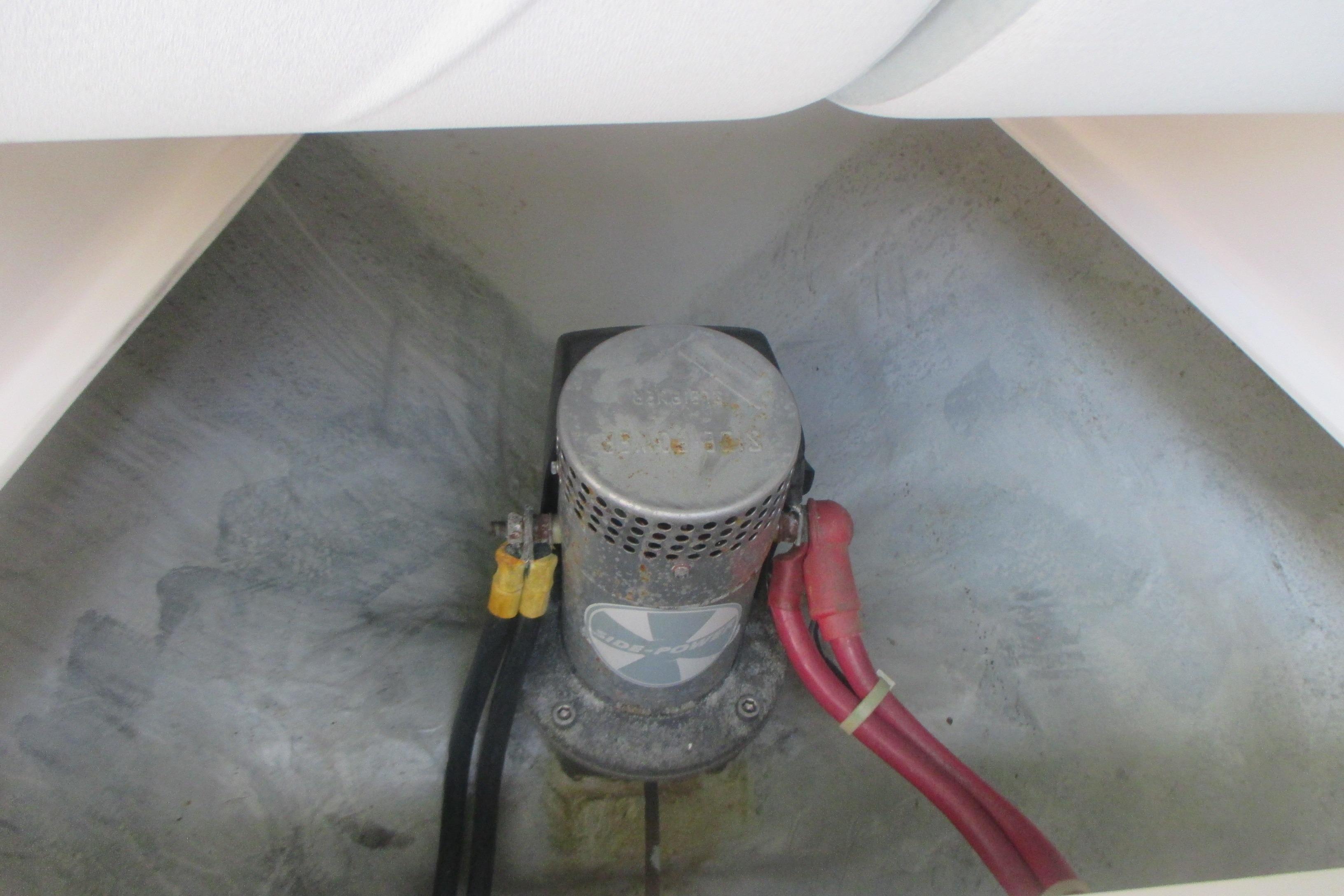 Bilge pump in a 2005 True North 33 boat, with red and black cables.