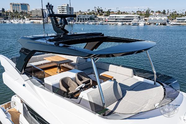 2025 Sunseeker Manhattan 68 luxury yacht on serene water with modern design.