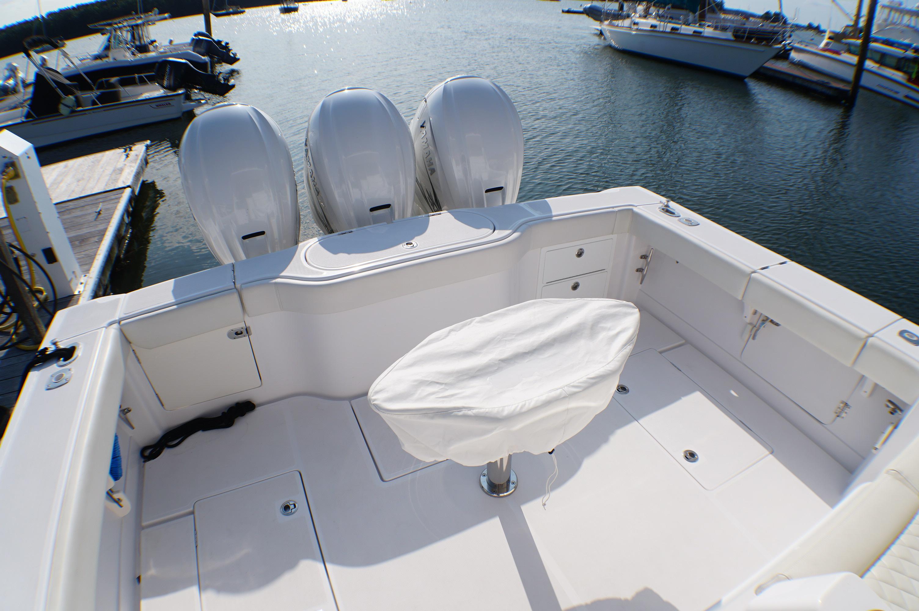 Jupiter 41 SB 2021 with triple outboard engines at dock.