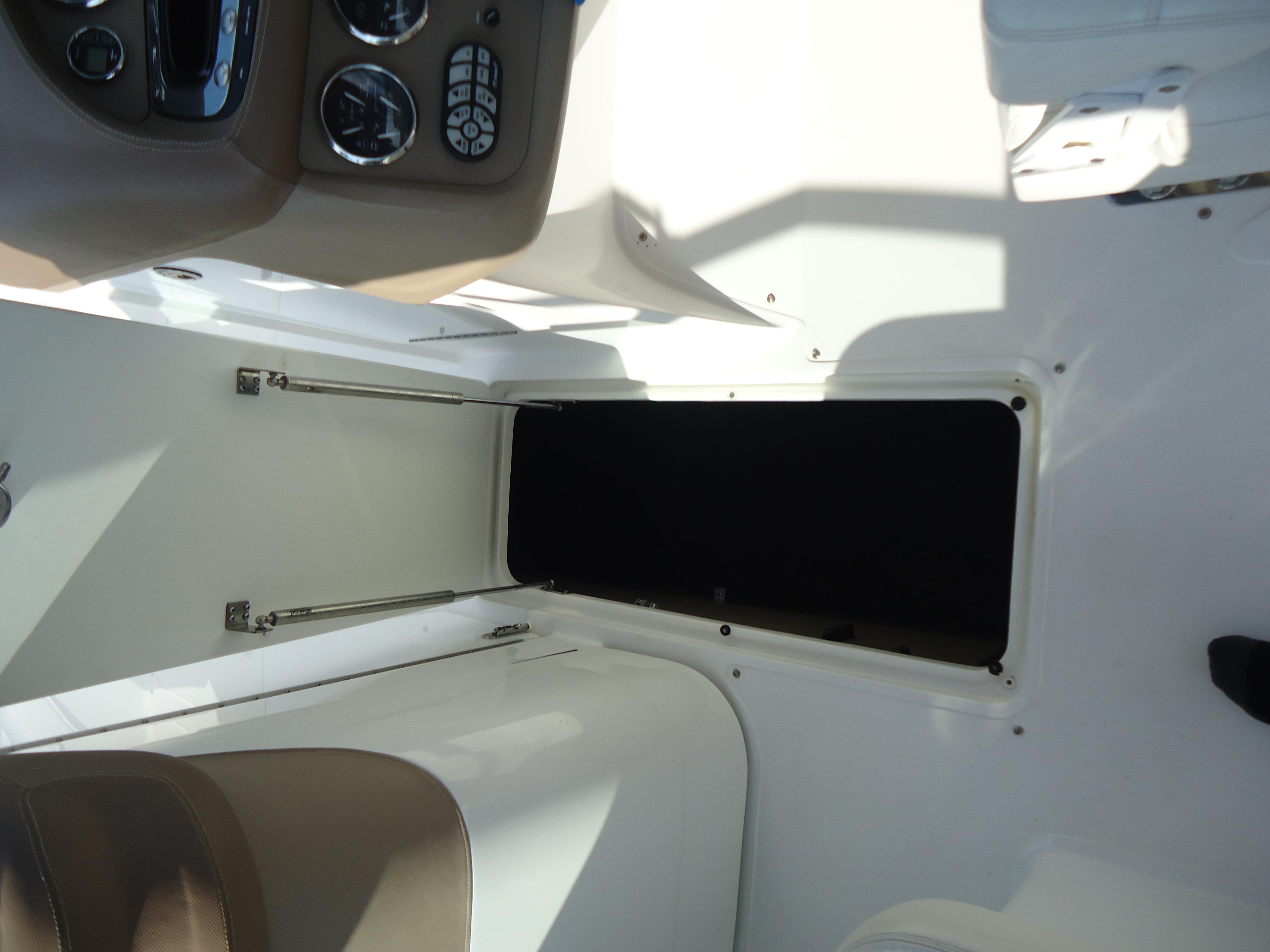 2007 Cobalt 302 boat interior with open storage compartment and control panel.