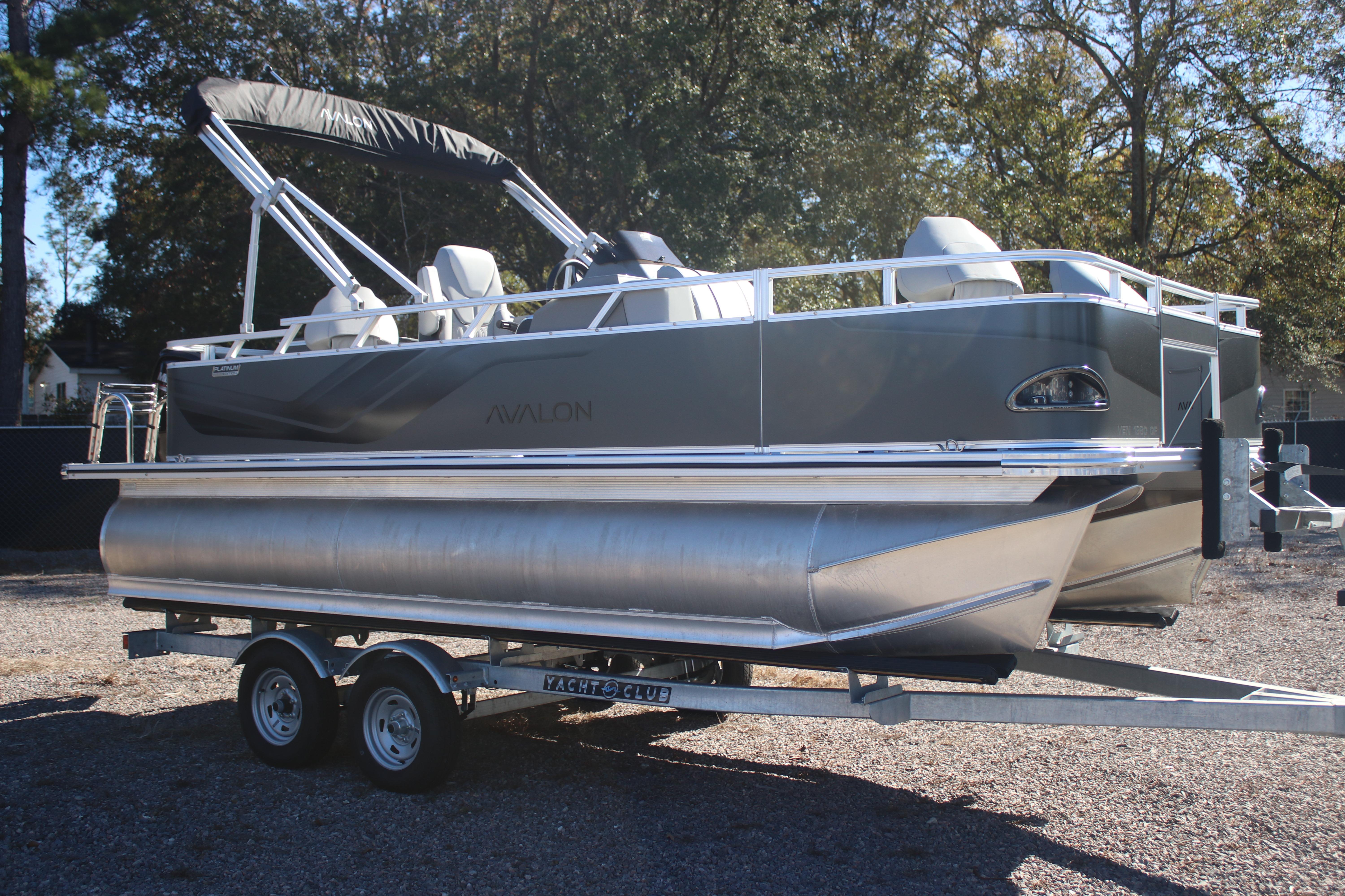 2026 Avalon VENTURE 85 QUAD pontoon boat on trailer, parked outdoors.