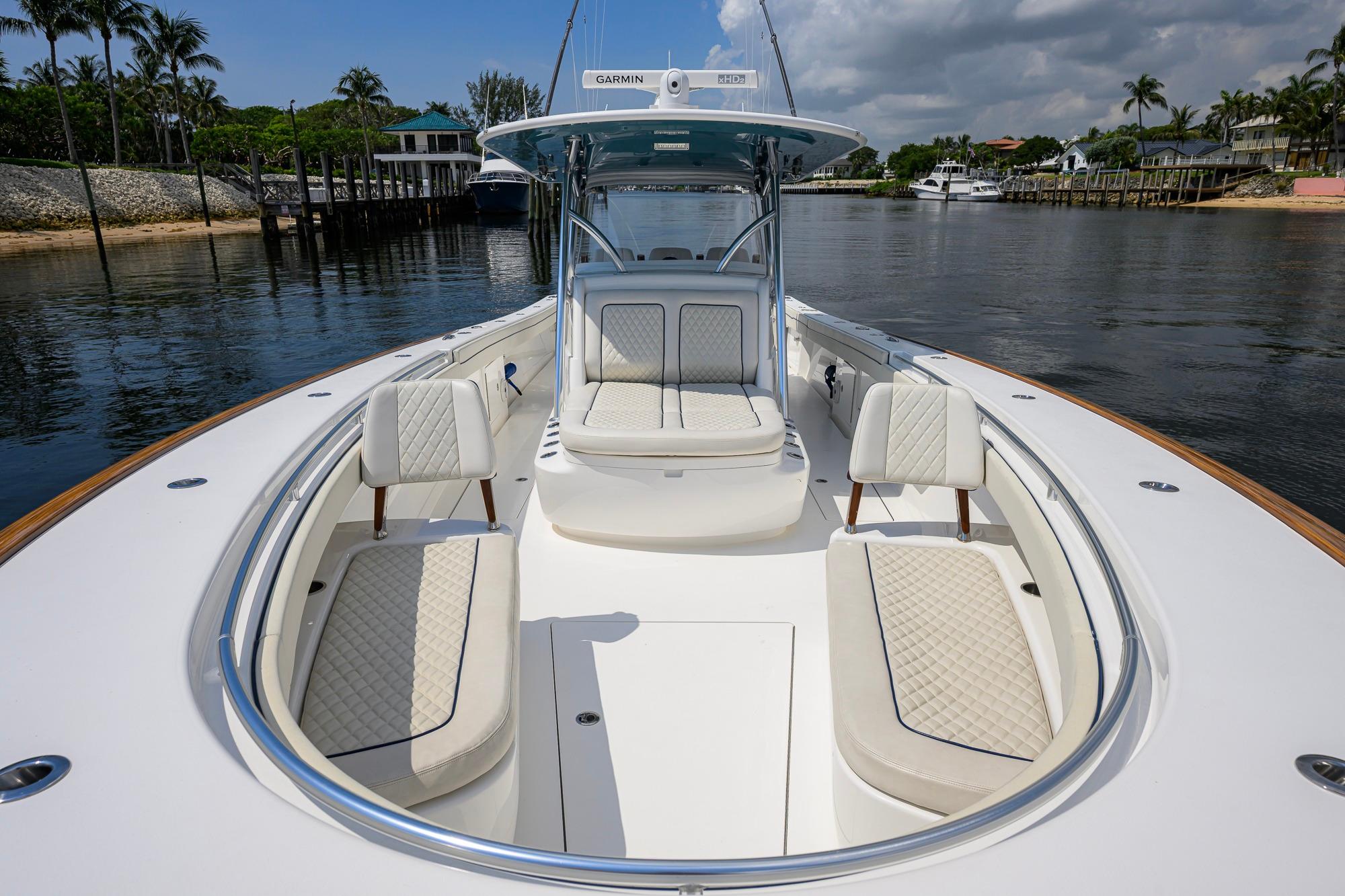 2020 Valhalla Boatworks V-41 with luxurious seating, docked in a serene waterfront setting.
