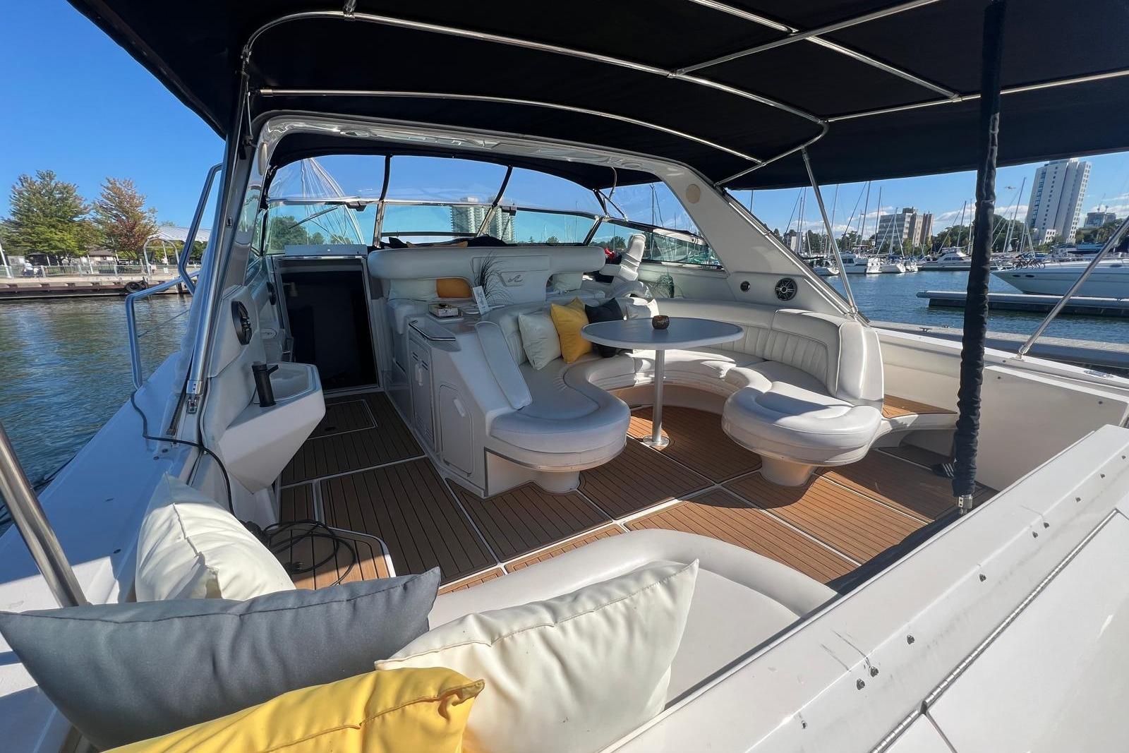 Luxurious 1997 Sea Ray 500 Sundancer yacht interior with plush seating and scenic marina view.