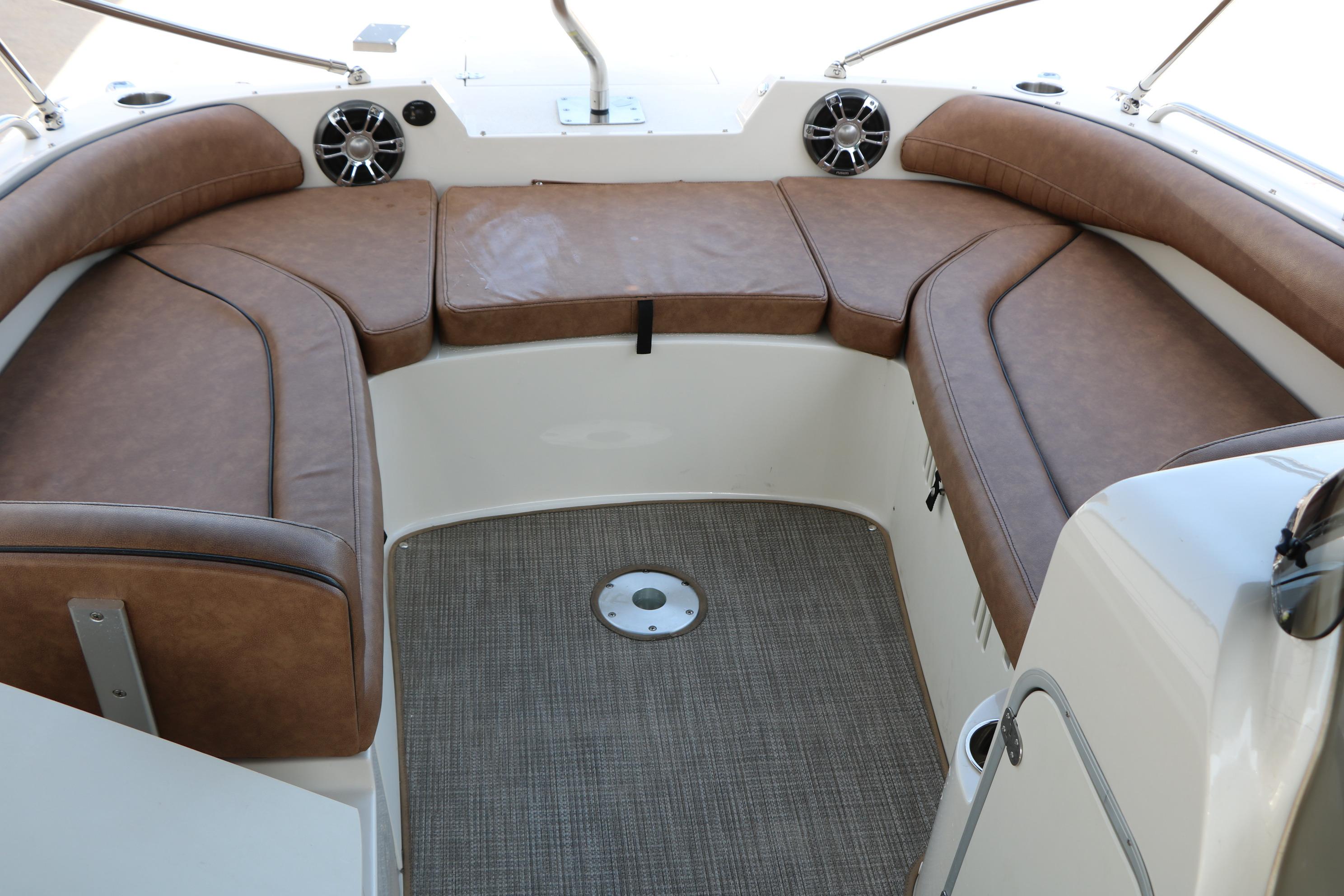 2022 Stingray 192 SC boat interior with brown cushioned seating and carpeted floor.