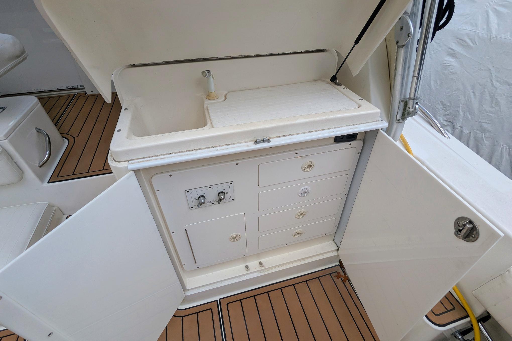 2002 Stamas 340 Express boat interior with sink and storage compartments.