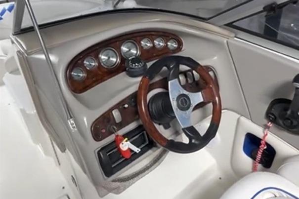 1999 Tide Craft Trophy Angler boat dashboard with steering wheel and instrument panel.