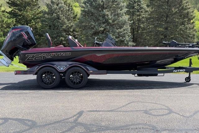 2026 Nitro Z21 XL Pro boat on trailer, parked outdoors with trees in background.