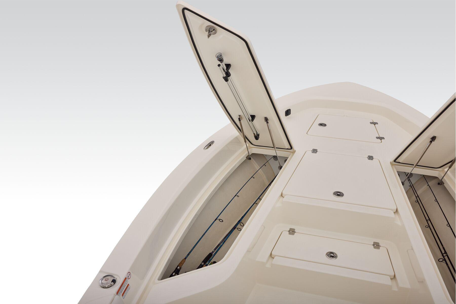 2026 Mako 24 APEX boat with open storage compartments on deck.