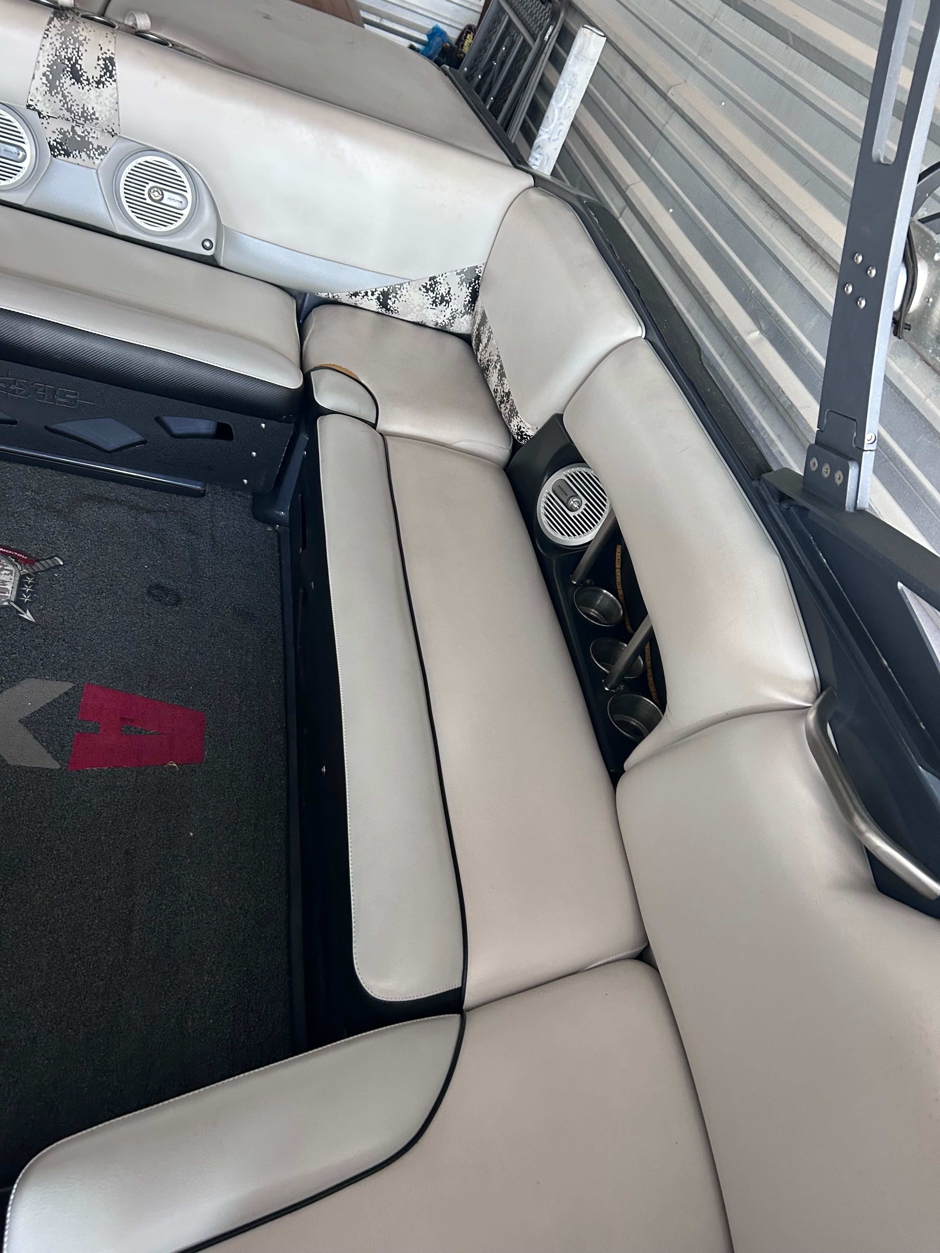 Interior of a 2013 Axis A22 boat with beige seating.