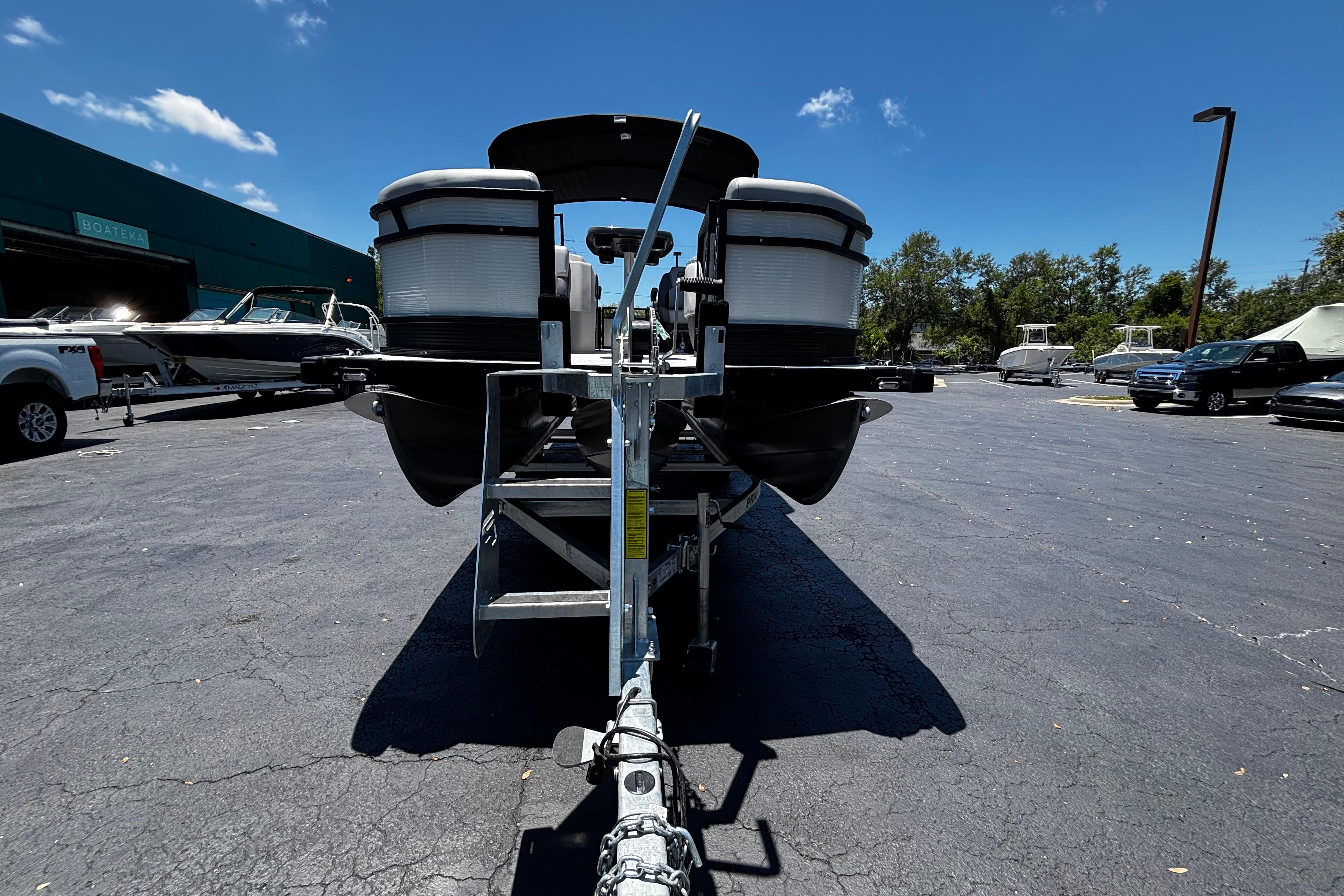 2026 Princecraft Vectra 23 QL pontoon boat on trailer in parking lot.