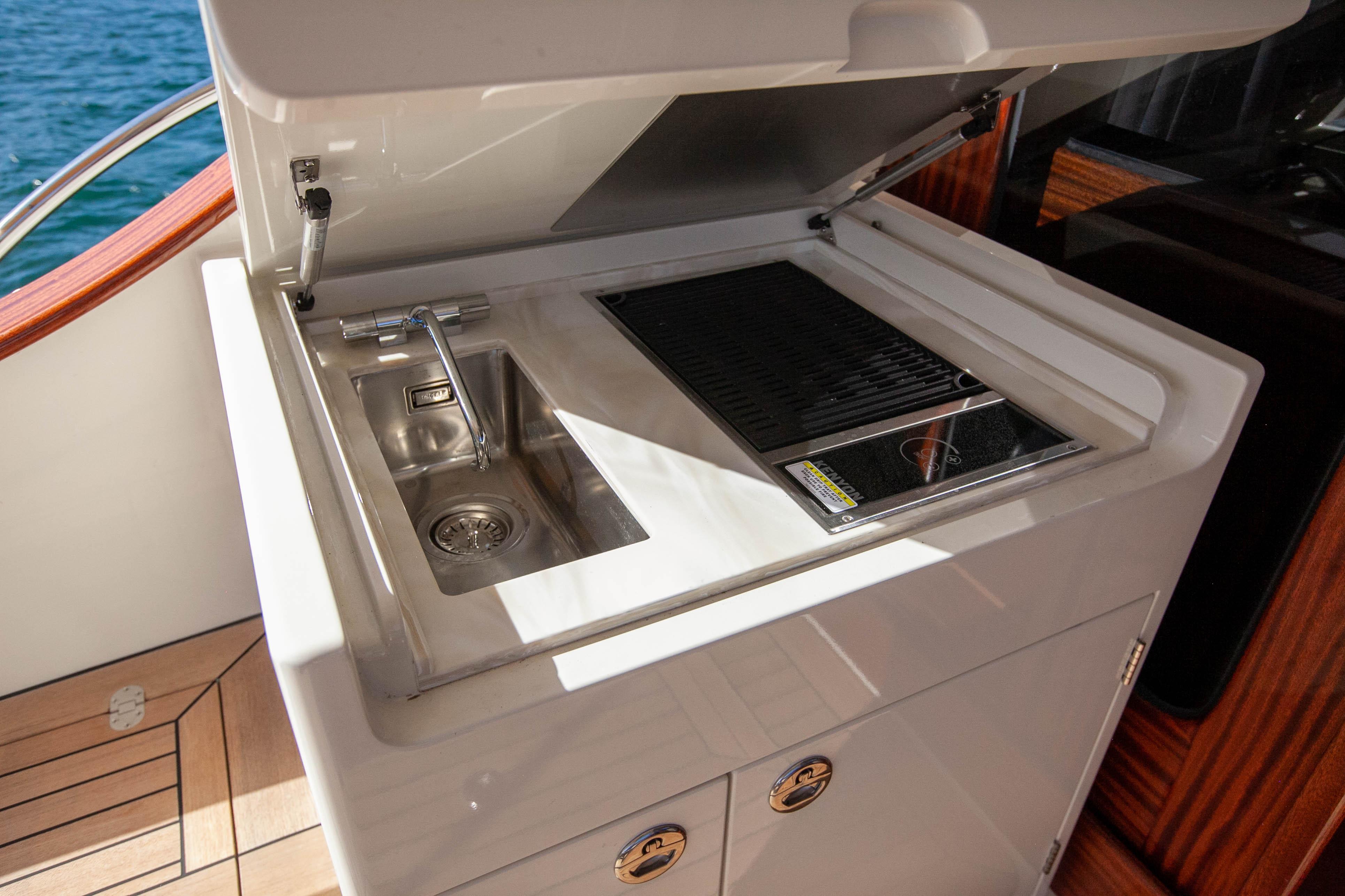 Outdoor kitchenette on 2023 Vicem 55 yacht with sink and grill.