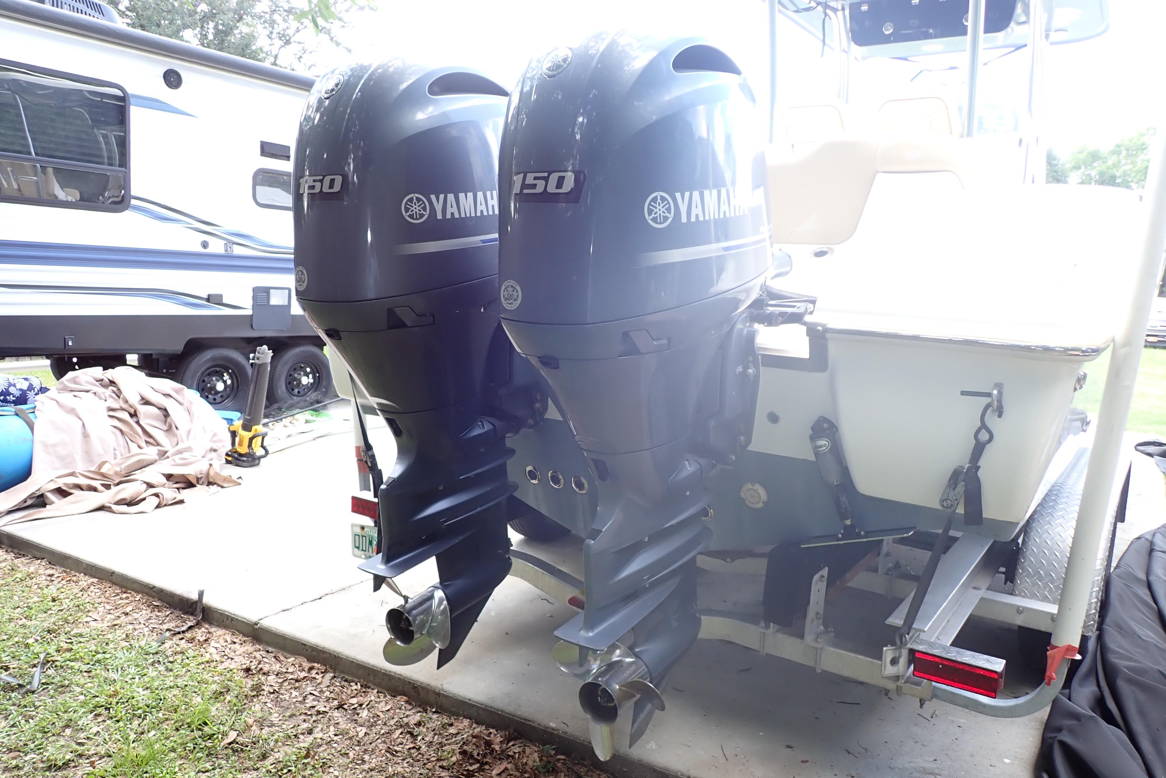 2019 Key West 263 FS boat with dual Yamaha 150 outboard motors, parked near an RV.
