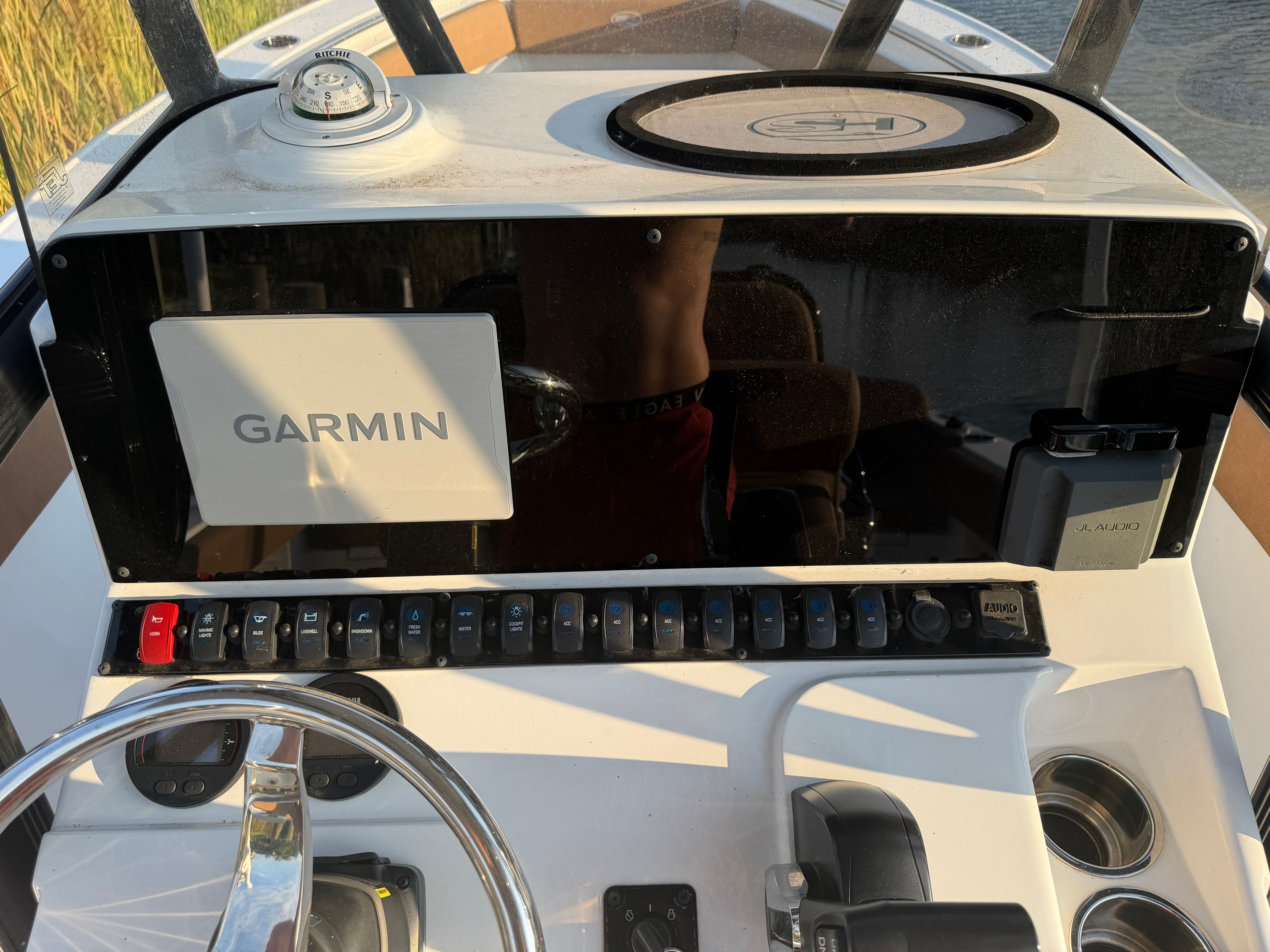 The image shows the dashboard of a Sea Hunt Ultra 219 boat with various instruments.