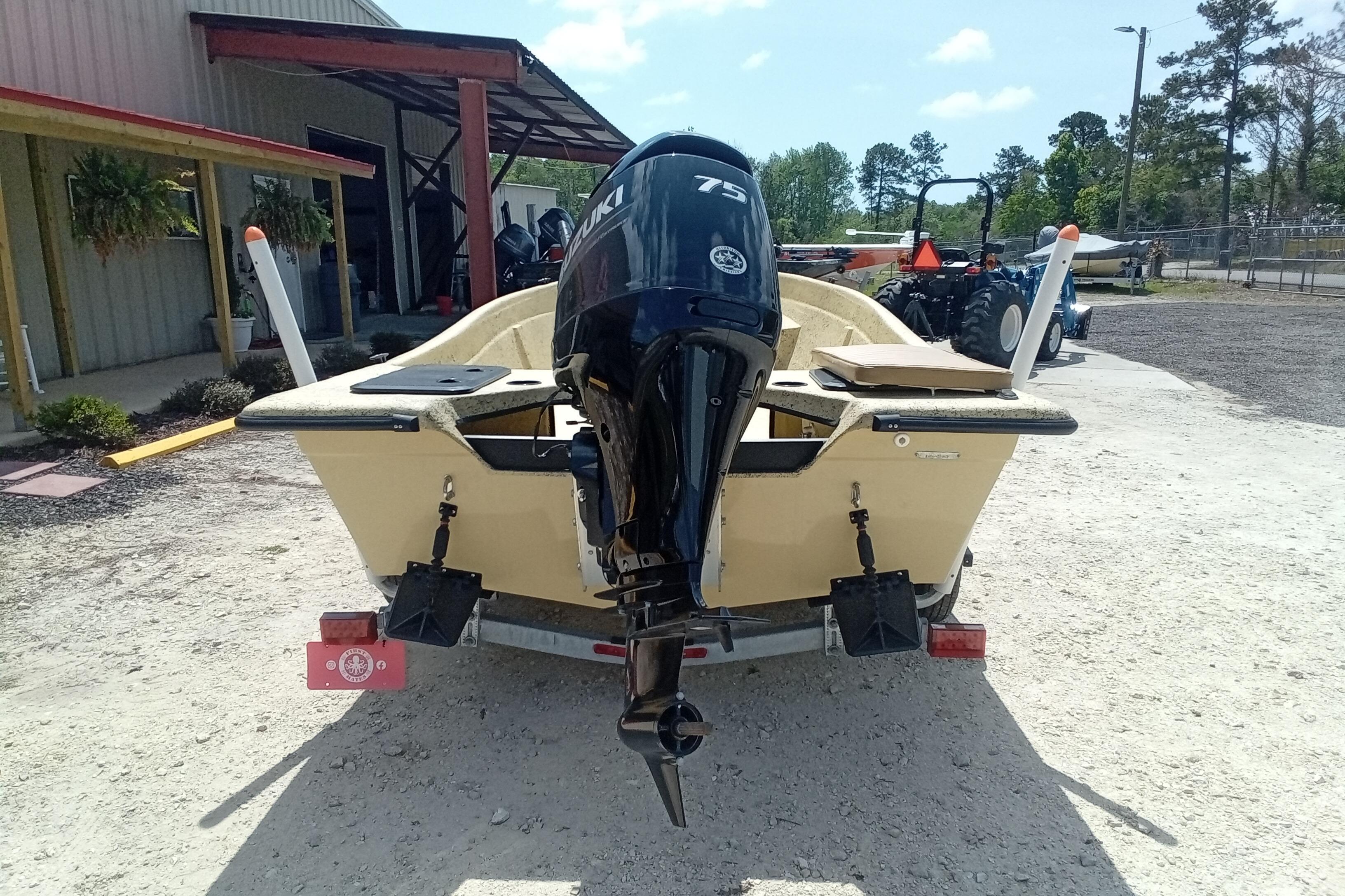 2025 Fibercraft F16 boat with Suzuki 75 outboard motor, parked outdoors.