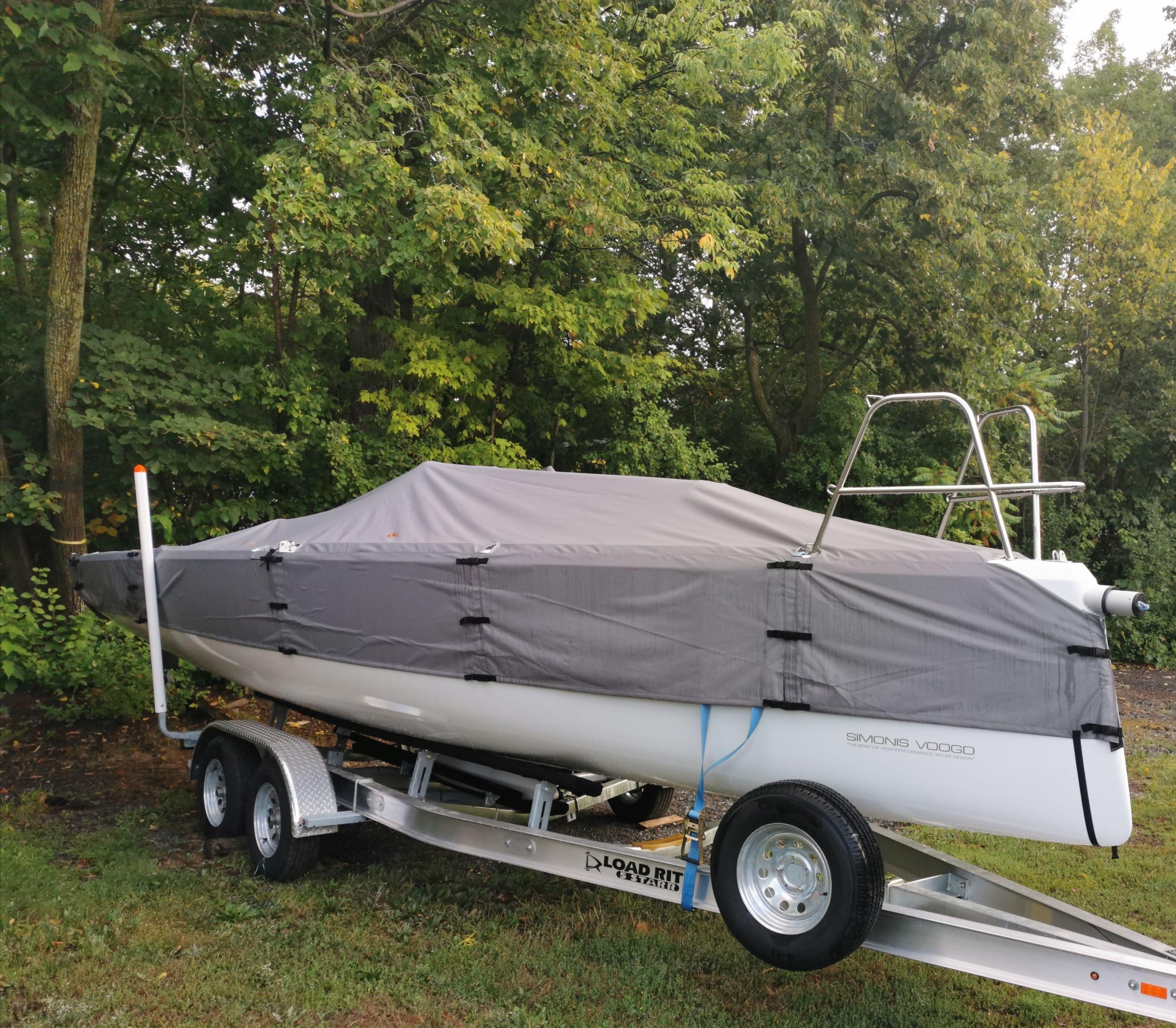 Covered FarEast 28R sailboat on trailer, surrounded by trees, 2025 model.
