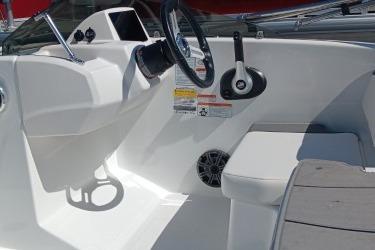 Interior view of a 2026 Tahoe T16 boat, featuring steering wheel and seating area.