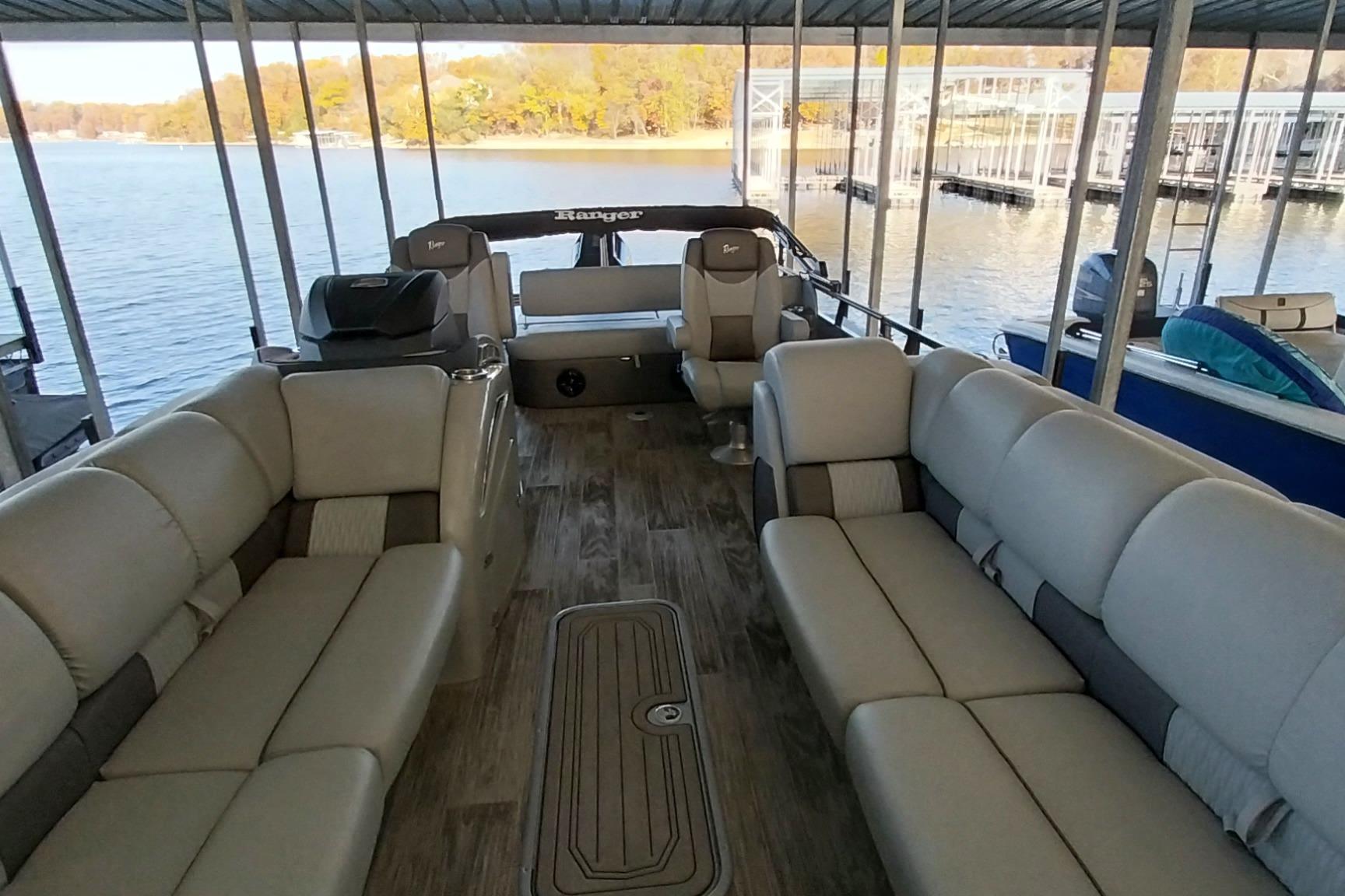 2023 Ranger 2500LS pontoon boat interior with spacious seating and scenic lake view.