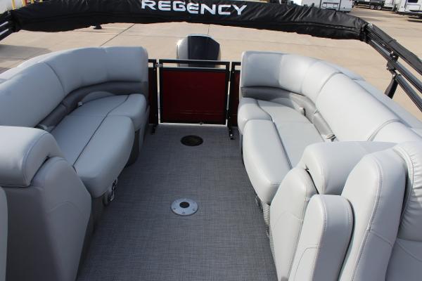 2025 Regency 230 DL3 pontoon boat with spacious gray seating and sleek design.
