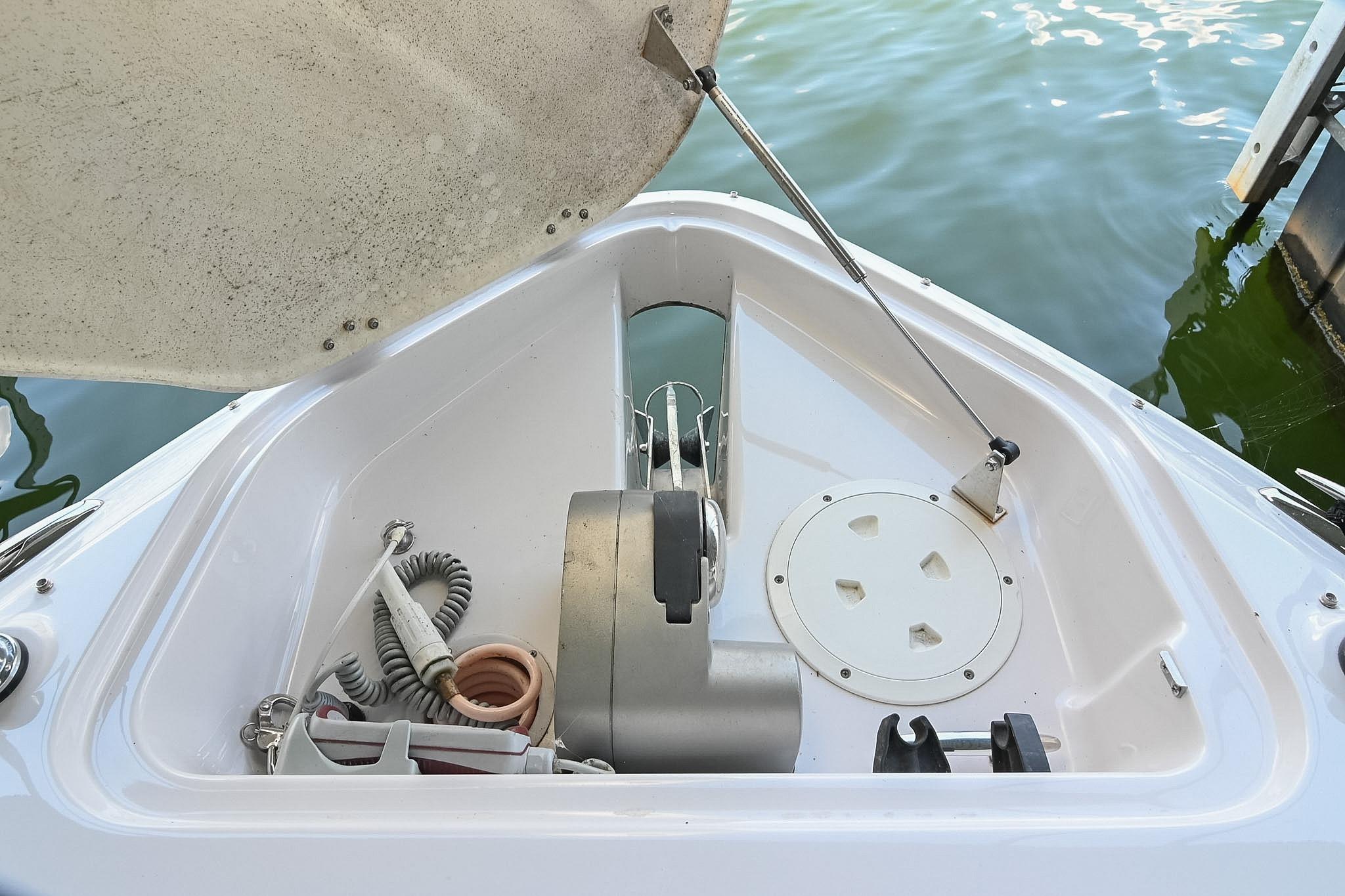 Open anchor compartment on 2014 Four Winns H290 boat, showing storage and equipment.