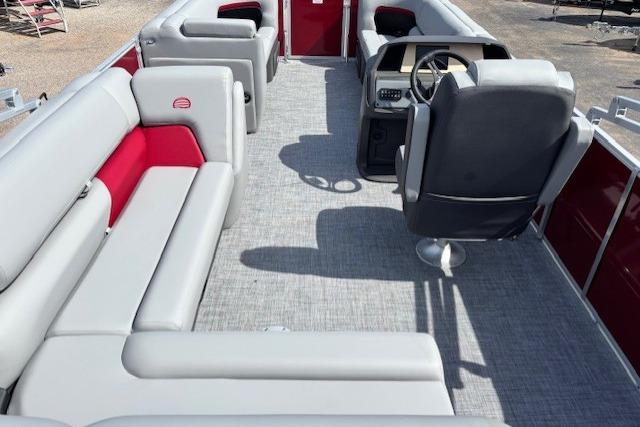2026 Sun Tracker Party Barge 20 DLX interior with gray seating and steering console.