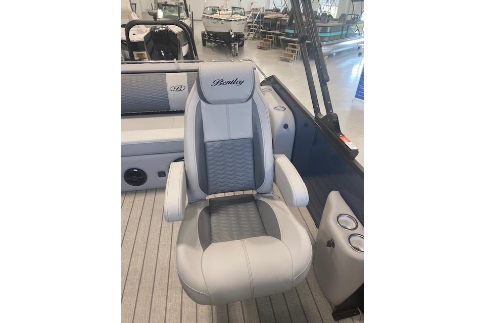 2026 Bentley Pontoons Elite 223 Swingback captain's chair in a luxury boat interior.
