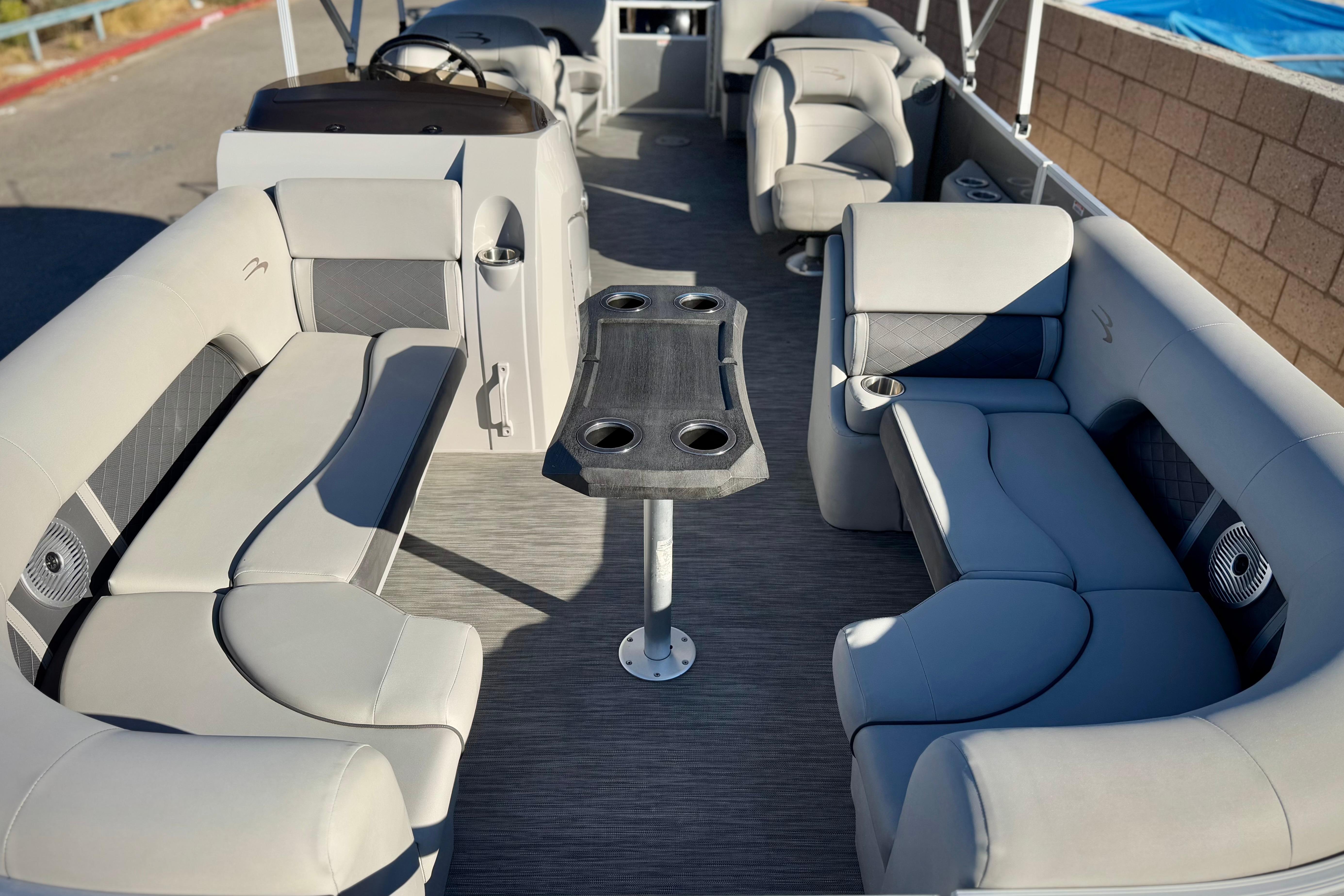 2021 Bennington 23LSR pontoon boat interior with luxurious seating and central table.