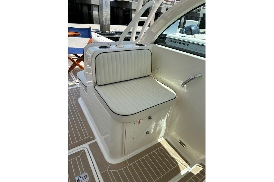 Interior seating of a 2013 Pursuit DC 265 Dual Console boat, featuring white cushioned seats.