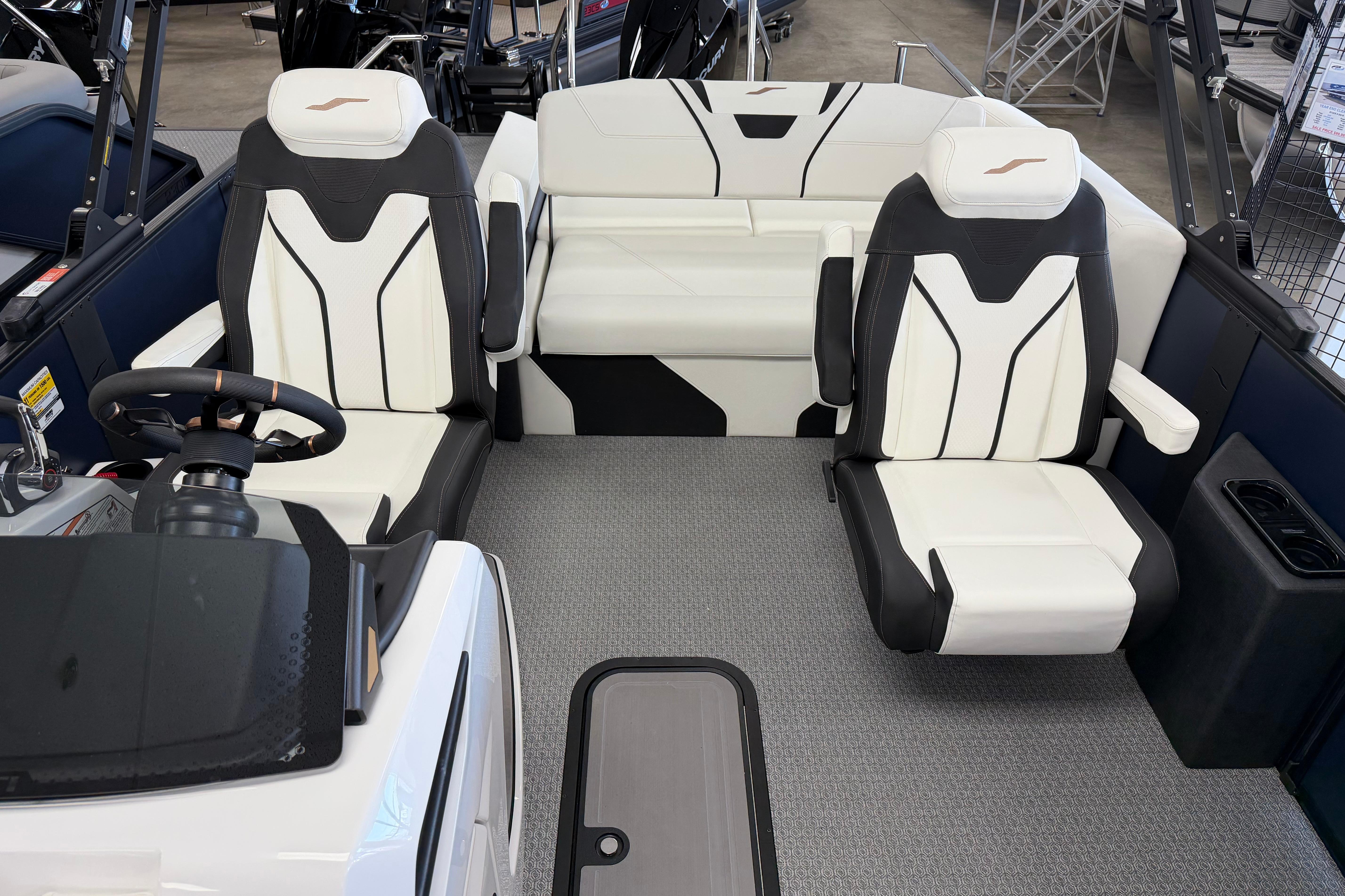 2026 Evotti 721CS boat interior with modern white and black seating, steering wheel, and dashboard.