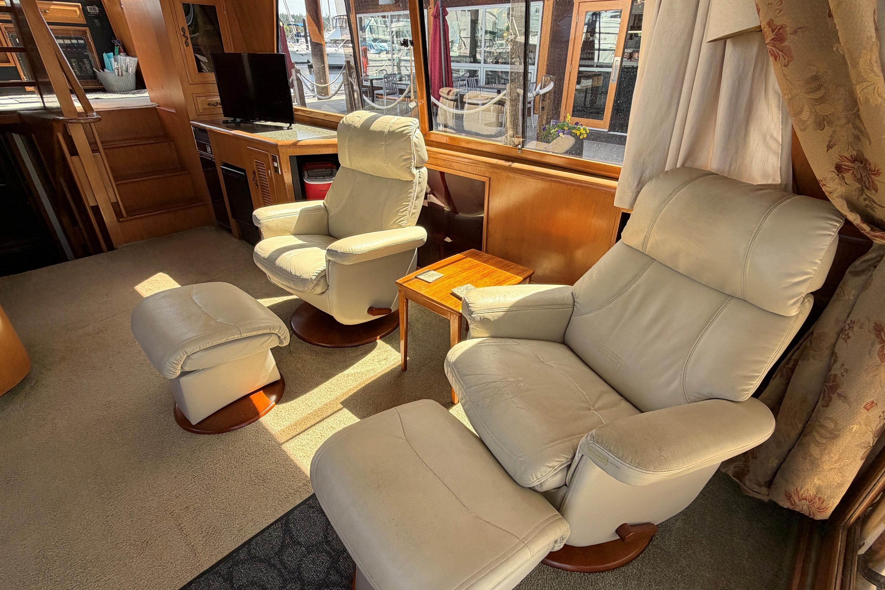 Luxurious interior of a 1988 Angel Pilothouse yacht with plush seating and elegant decor.