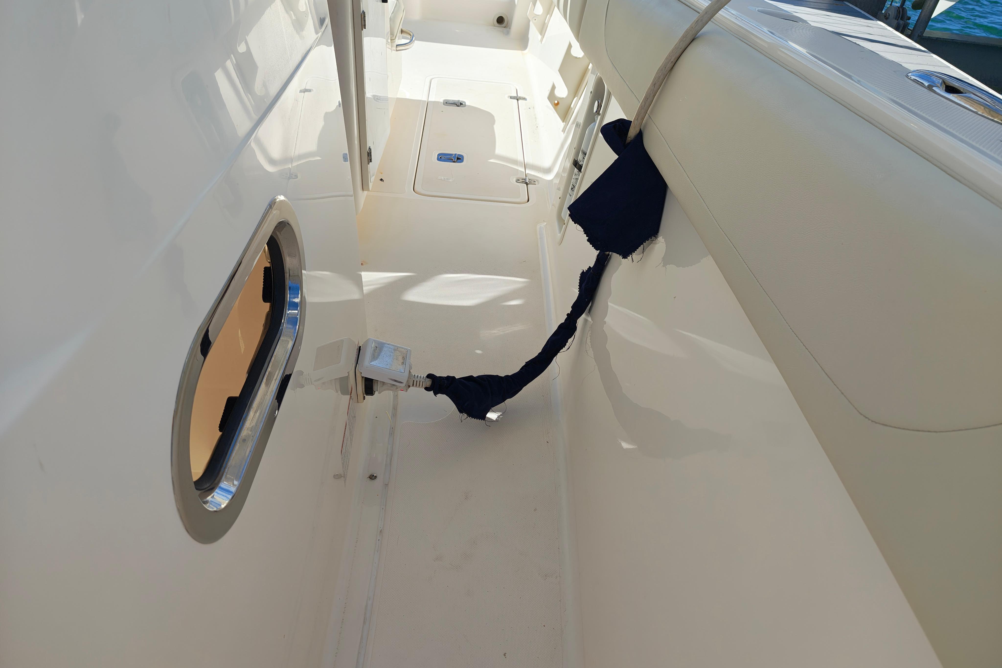 2012 Pursuit C 310 Center Console interior with clean white deck and secured rope.