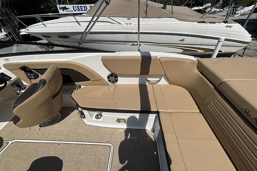 2019 Sea Ray SPX 230 Outboard interior with tan seating and steering console.