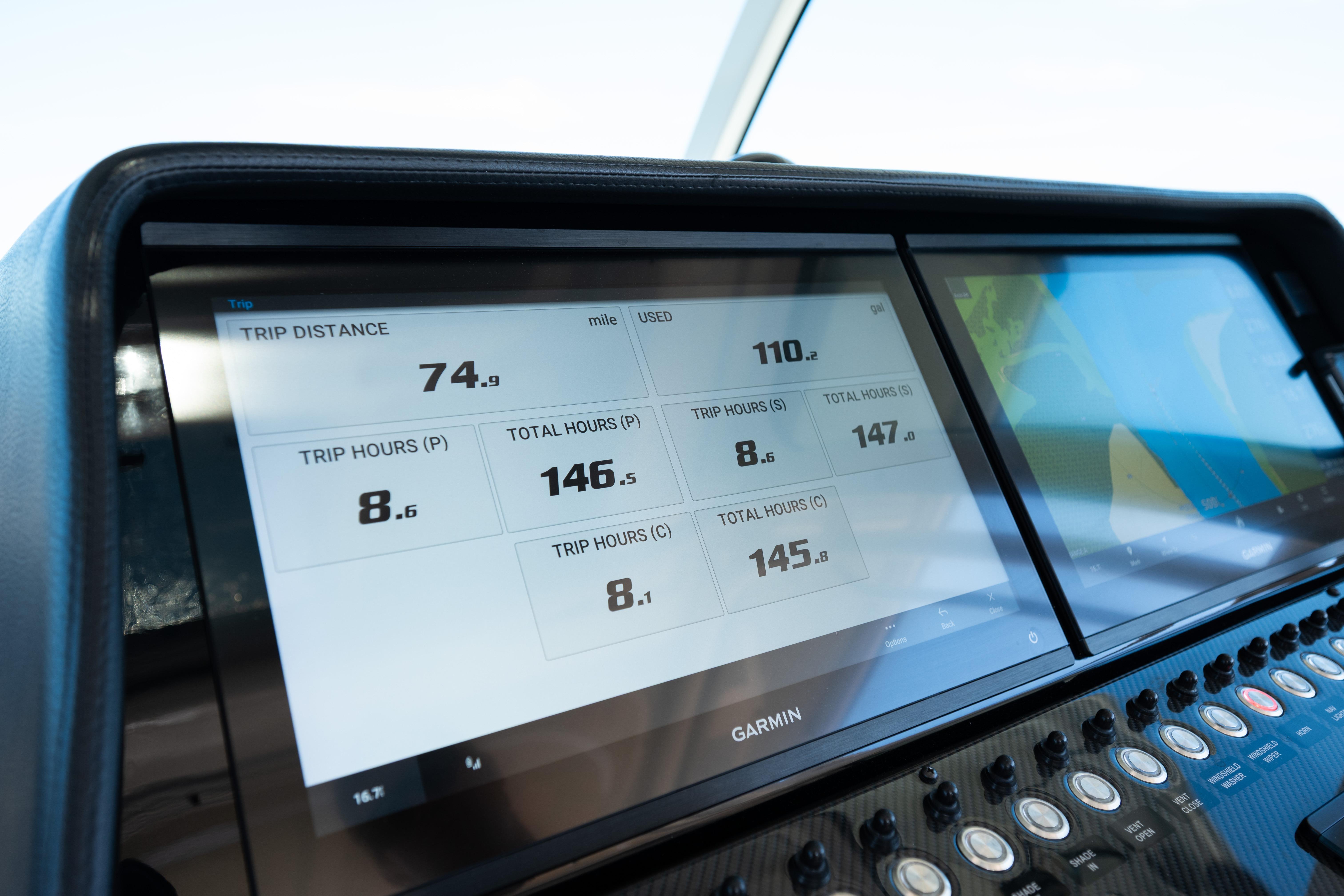 Dashboard of 2025 Grady-White Canyon 386 boat with Garmin display showing trip data.