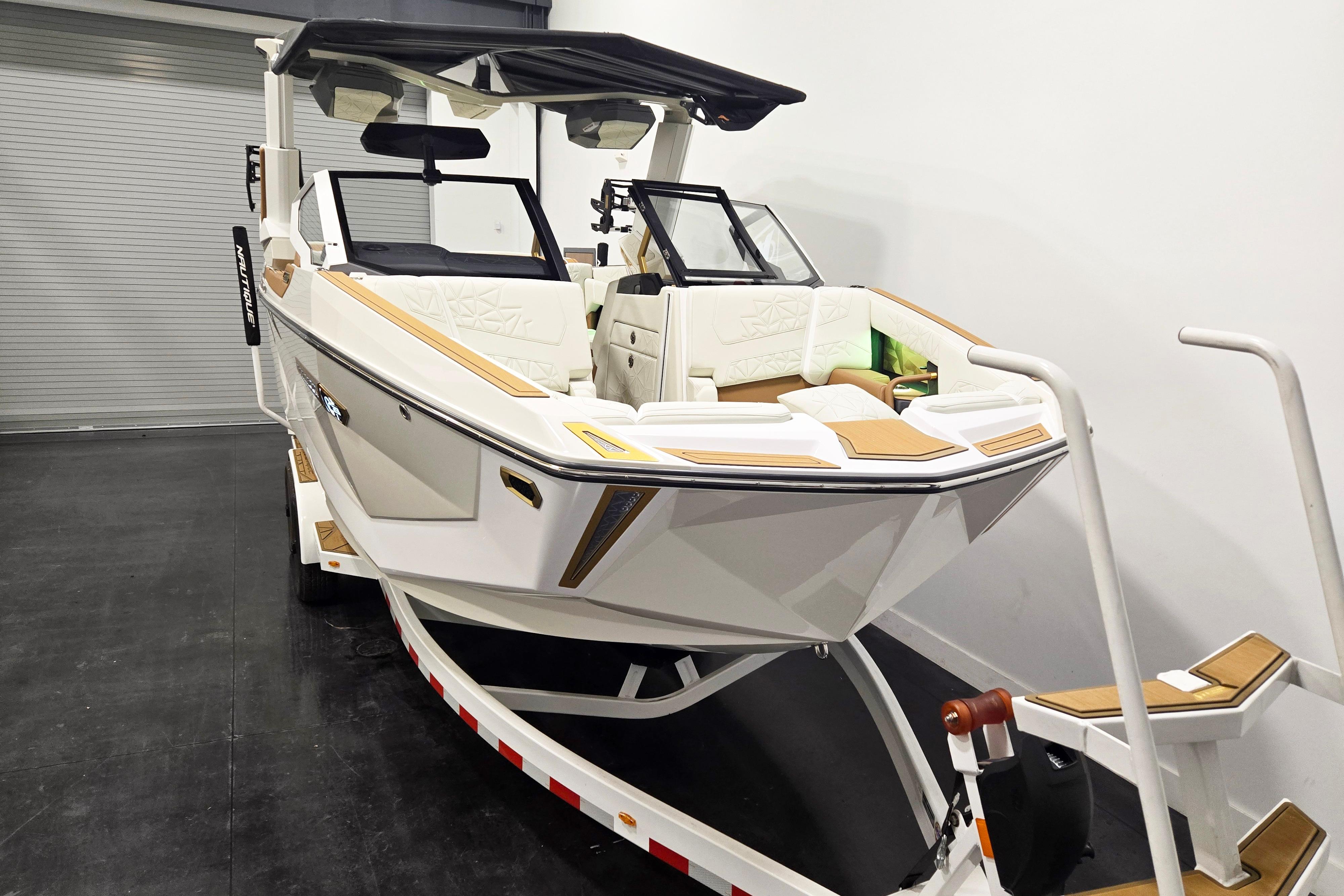 2026 Nautique Super Air Nautique G23 Paragon boat on trailer in showroom.