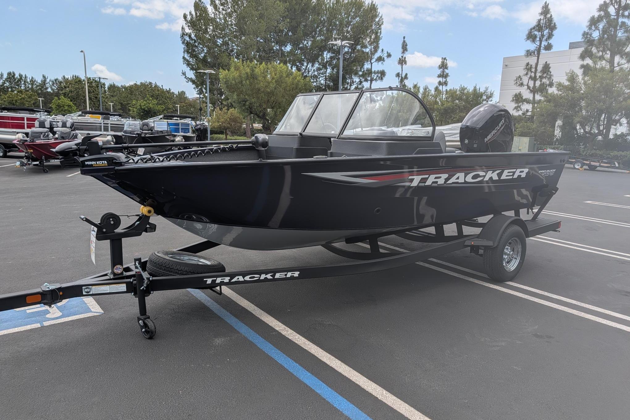 2026 Tracker Pro Guide V-175 WT boat on trailer in parking lot.