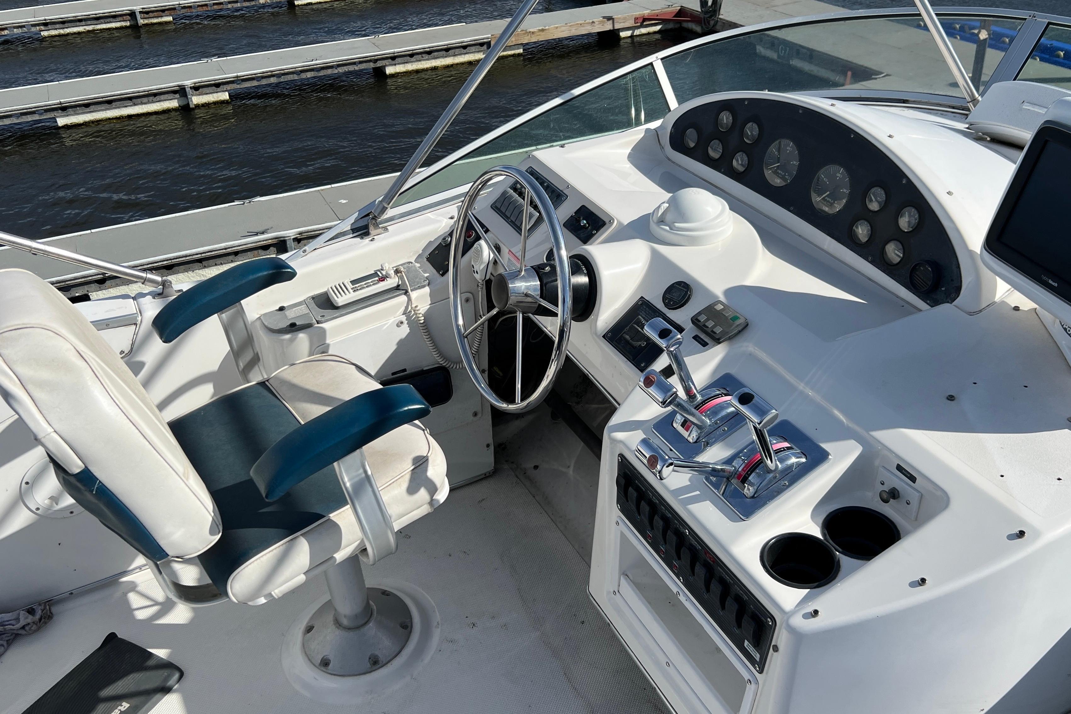 1998 Bayliner 3988 Command Bridge Motoryacht helm with steering wheel and control panel.